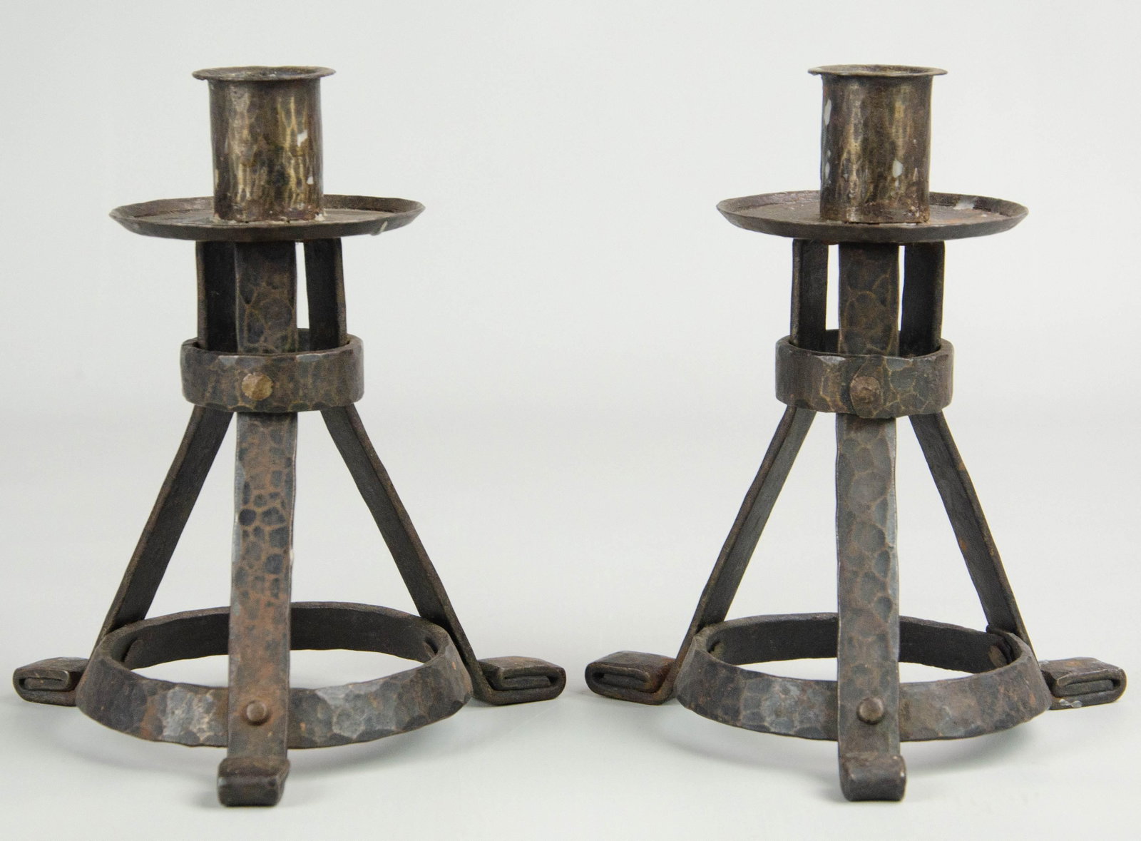 Edgar Brandt Signed Candlesticks: Edgar Brandt (1880-1960) signed candlesticks c/o wrought iron conical form bases on hammered rolled feet with hammered bobeche and cup at top, signed 'EB', 6-1/2" h