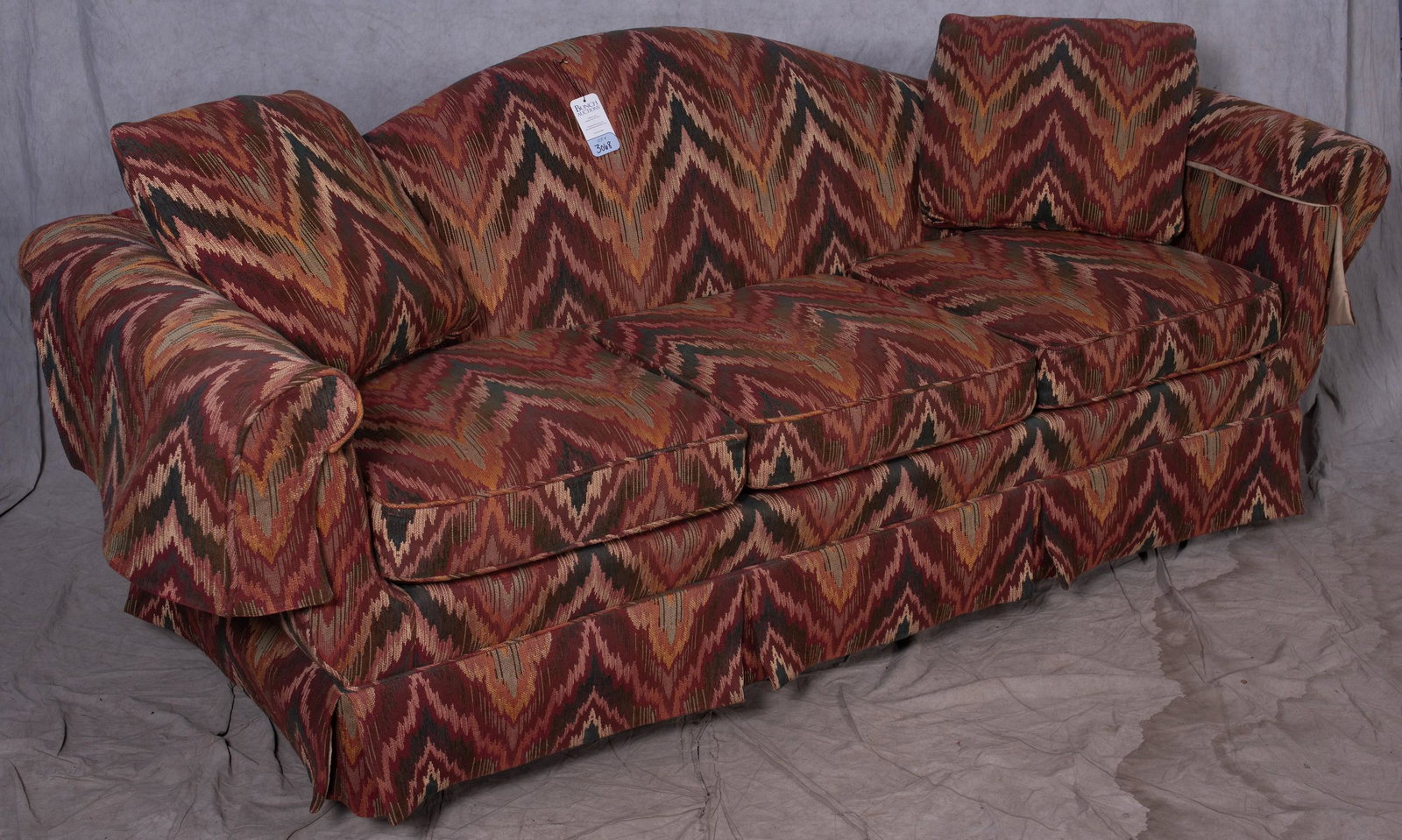Baker camelback upholstered sofa: Baker camelback upholstered sofa, flame stitched upholstery, 34" h x 88" w x 33" d