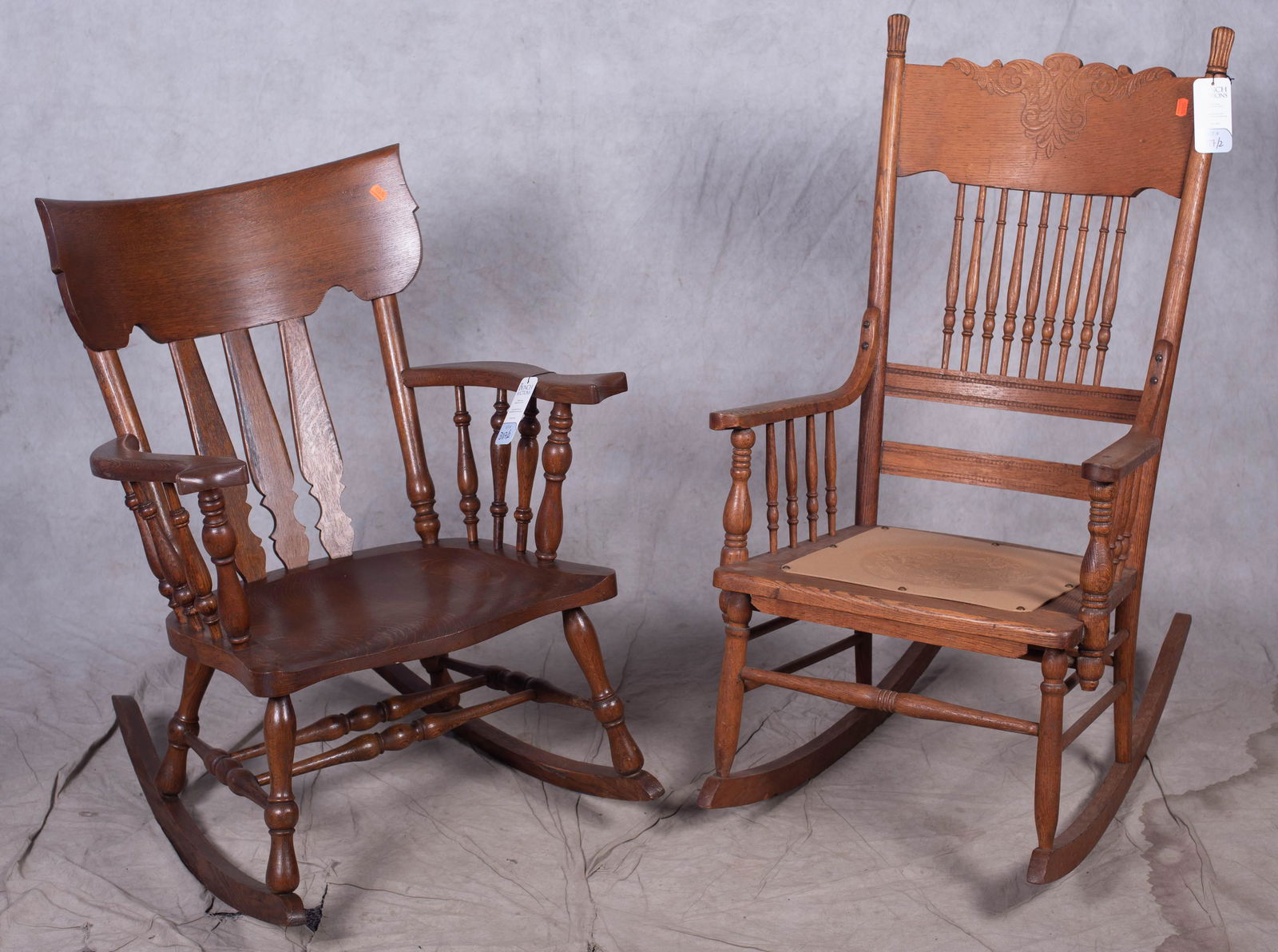 (2) rocking chairs: (2) rocking chairs, c/o one oak with spindle sides and stretcher, second oak carved with leather embossed seat, largest 43" h, seat height 17" h