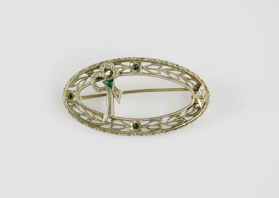 Antique Filigree 14K White Gold Brooch: 14K White gold antique brooch pin 31mmx17mm this brooch has One small 1.4mm Single cut Diamond and 4 green stones.
