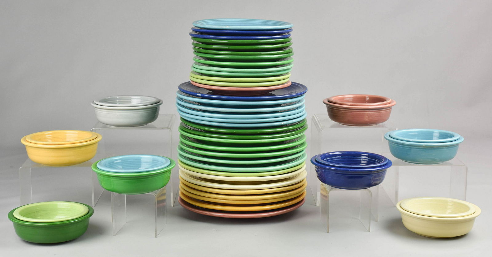 (50) Pcs Vintage Fiestaware: (50) Pcs vintage Fiestaware c/o (2) cream dinner plates, (2) cream bowls, 4" and 4-1/2" (1) chartreuse dinner plate, (2) chartreuse salad plates, (1) chartreuse bowl, 4" (1) cobalt dinner plate, (2) c