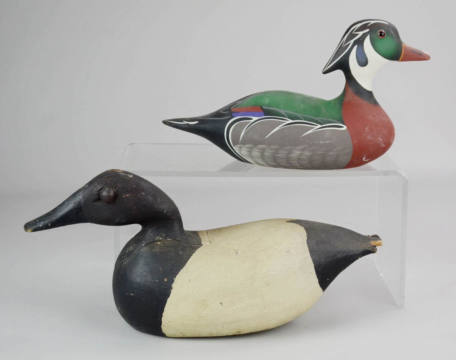 (2) Duck Decoys: (2) Duck decoys, including Wood Duck Stoney Point Decoys 24767, signed Shirley Hearne, stamped Johnny L Ennis 1988, largest 15" l x 6-3/4" h with damaged tail and some losses on rump.