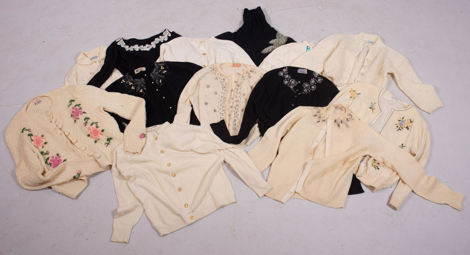 (13) 50's/60's Decorated Cashmere and Wool Sweaters: (13) 50's/60's Decorated cashmere and wool sweaters in embroidered, floral decorated, rhinestone and faux pearl decoration as well as gold tone and fau gem buttons. All s/m