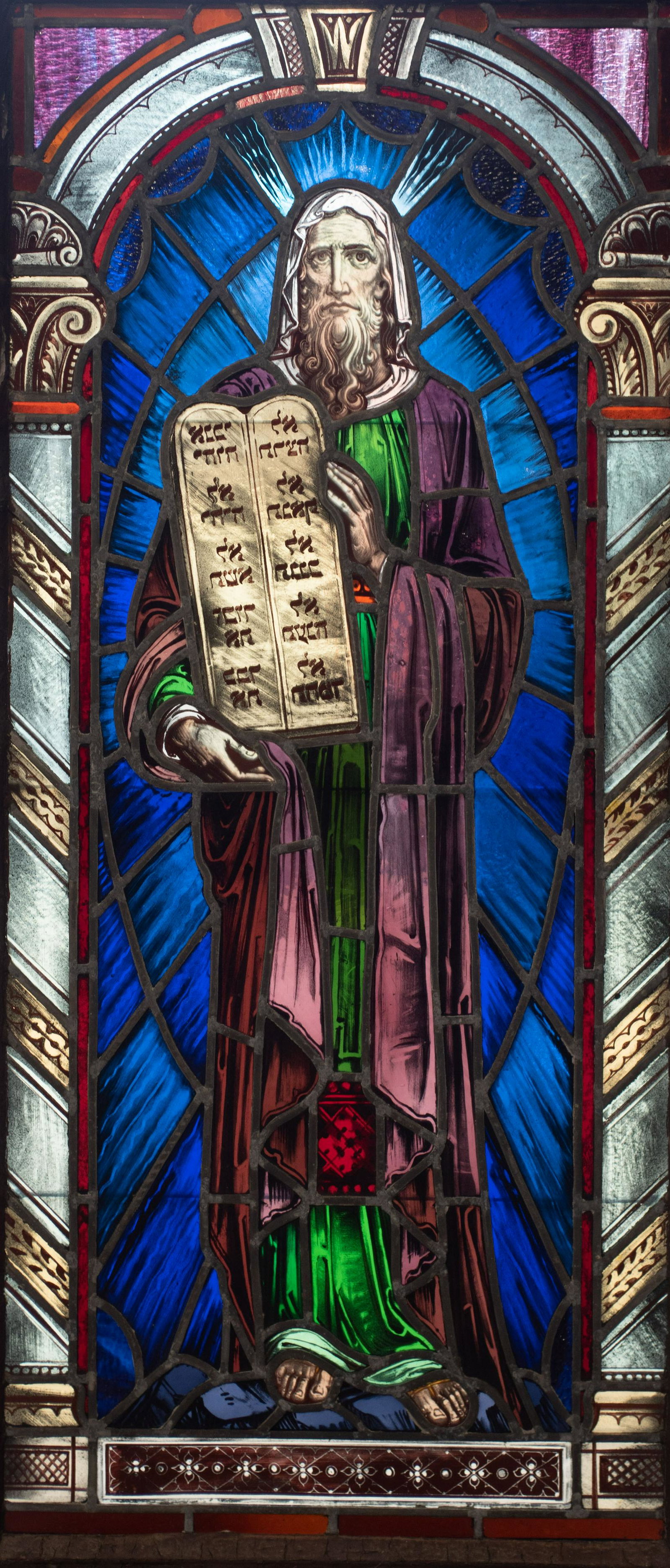 Stained glass window of Moses with 10 Commandments: Stained glass window of Moses with 10 Commandments, probably 19th c, metal frame, some applied decoration, excellent condition, 56-1/2" h x 25-1/2" w