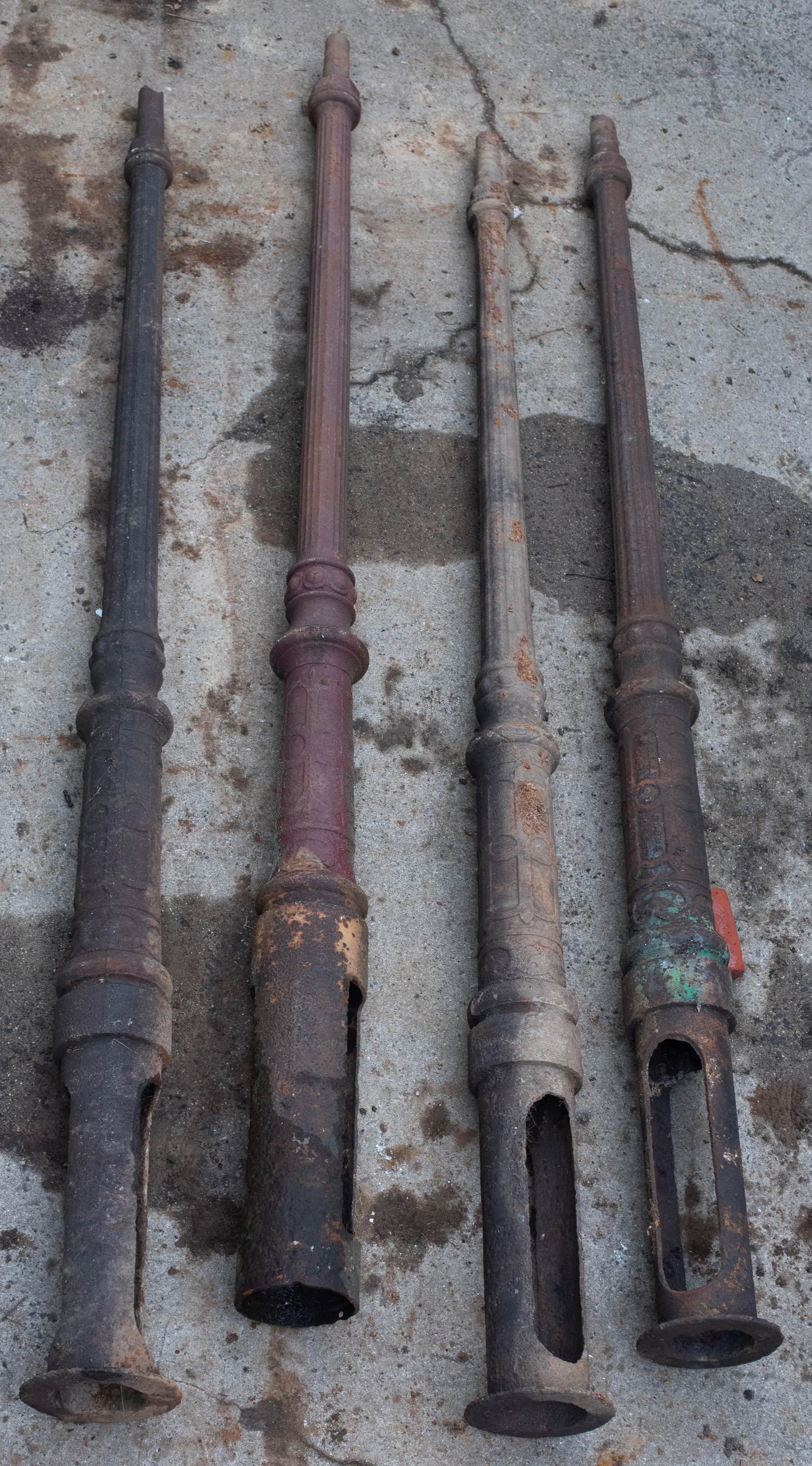 (4) fluted post cast iron light poles, 19th c, 136" h: (4) fluted post cast iron light poles, top section of column with a tapered fluted design, lower part round with recessed panel design, 136" overall length, effective length when installed 101" to sho