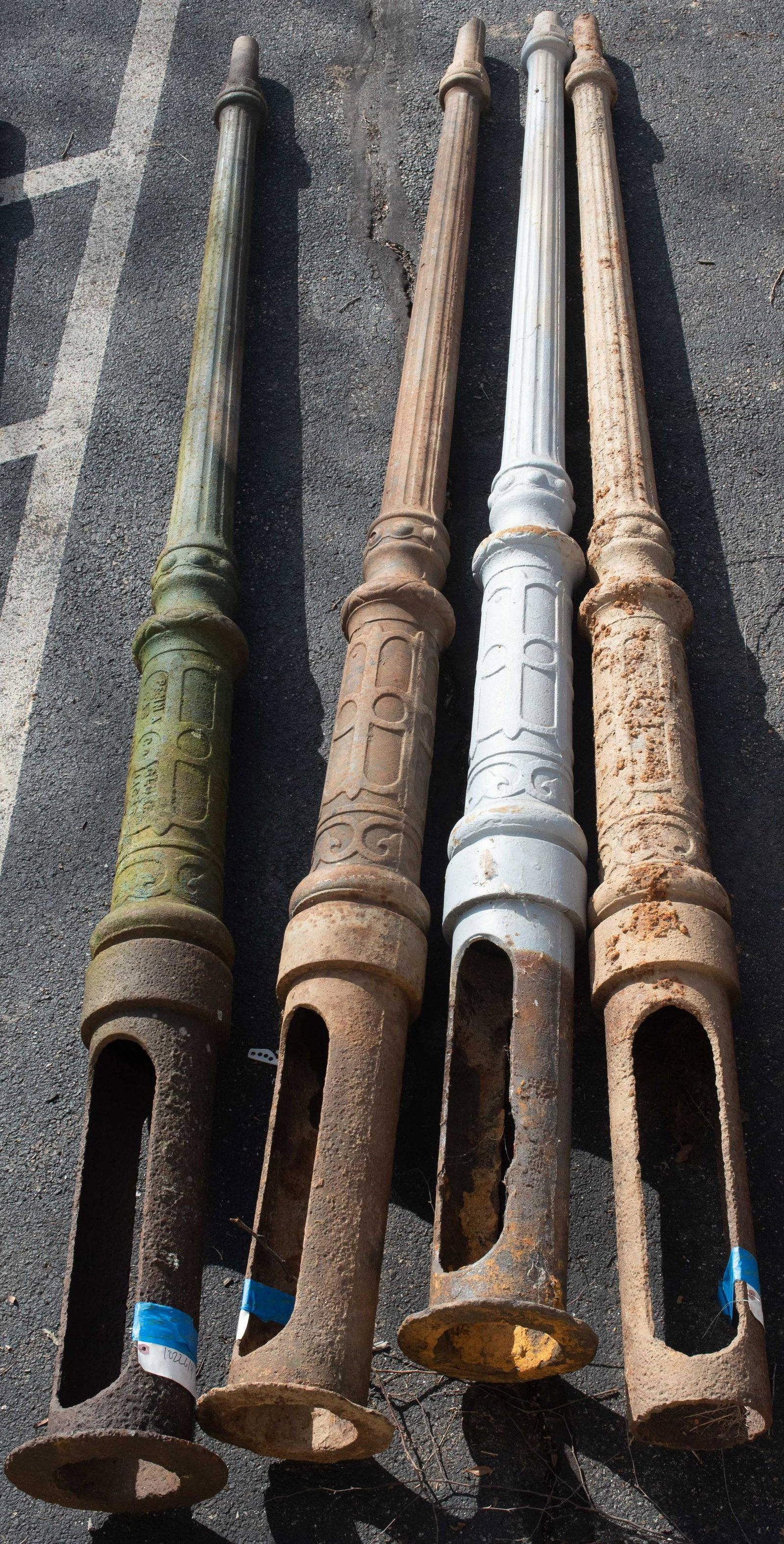 (4) fluted post cast iron light poles, 19th c, 136" h: (4) fluted post cast iron light poles, top section of column with a tapered fluted design, lower part round with recessed panel design, 136" overall length, effective length when installed 101" to sho