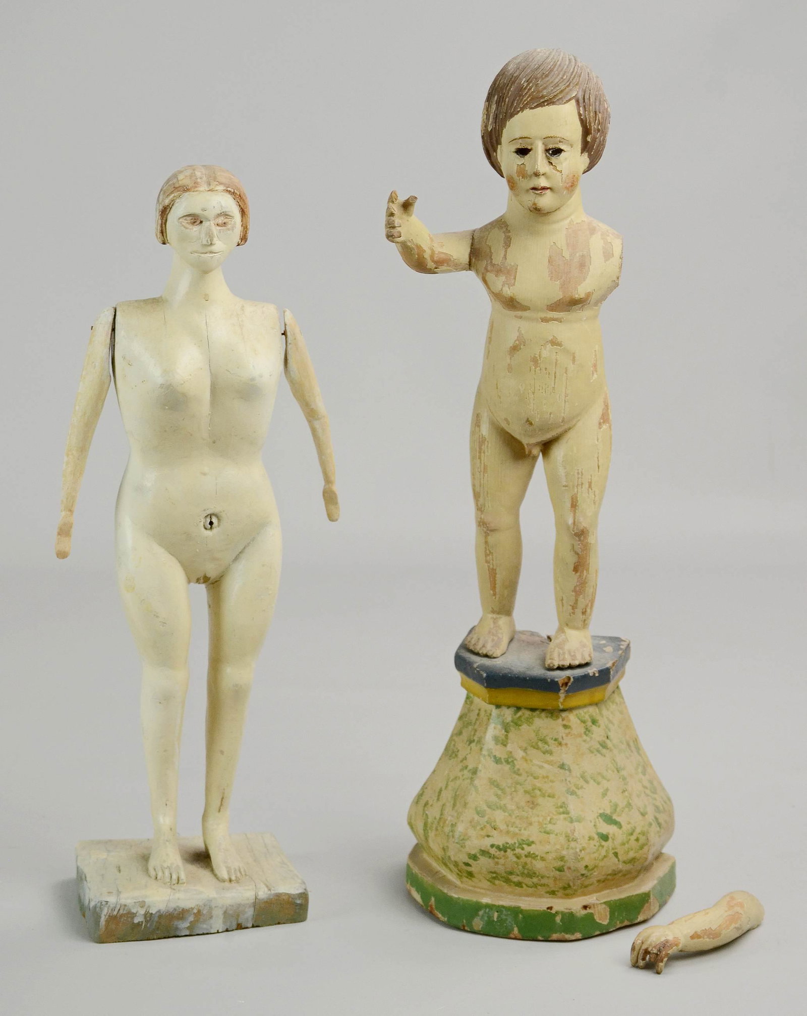 (2) Carved Articulated Figures: (2) Carved articulated figures c/o (1) carved and painted wood figure of nude woman, 13" h and (1) carved and painted wood figure of young boy on stand, one arm detached, 15" h