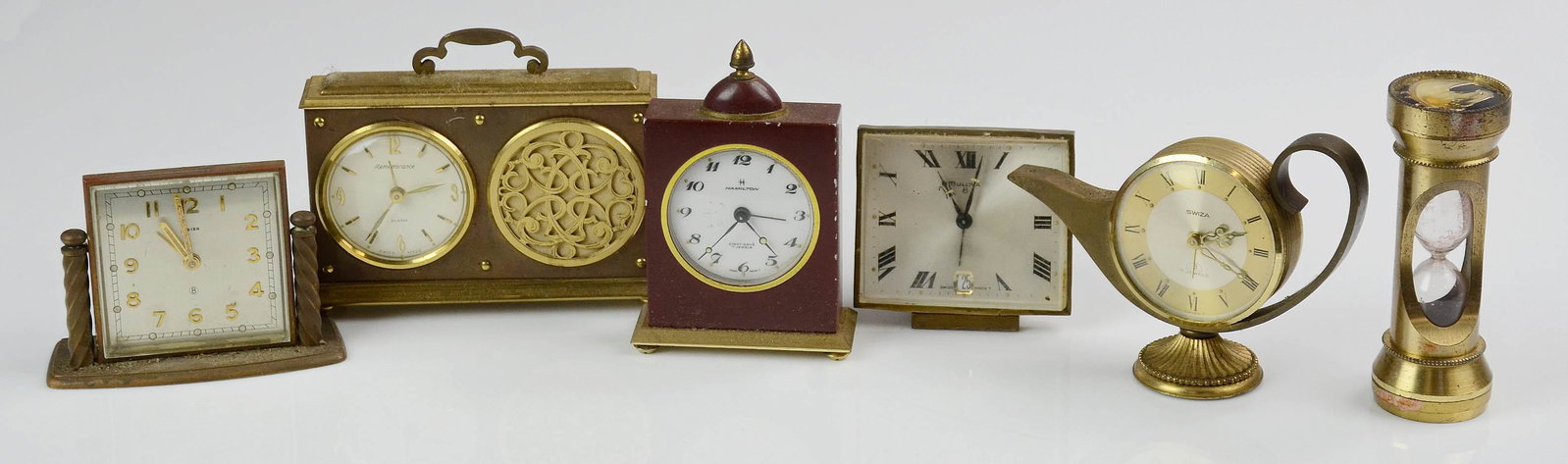 (6) Miniature Desk Clocks: (6) Miniature desk clocks, including Swiza Aladdin form, Hamilton, Endura hourglass (missing sand), Bulova, Remembrance, tallest 4"