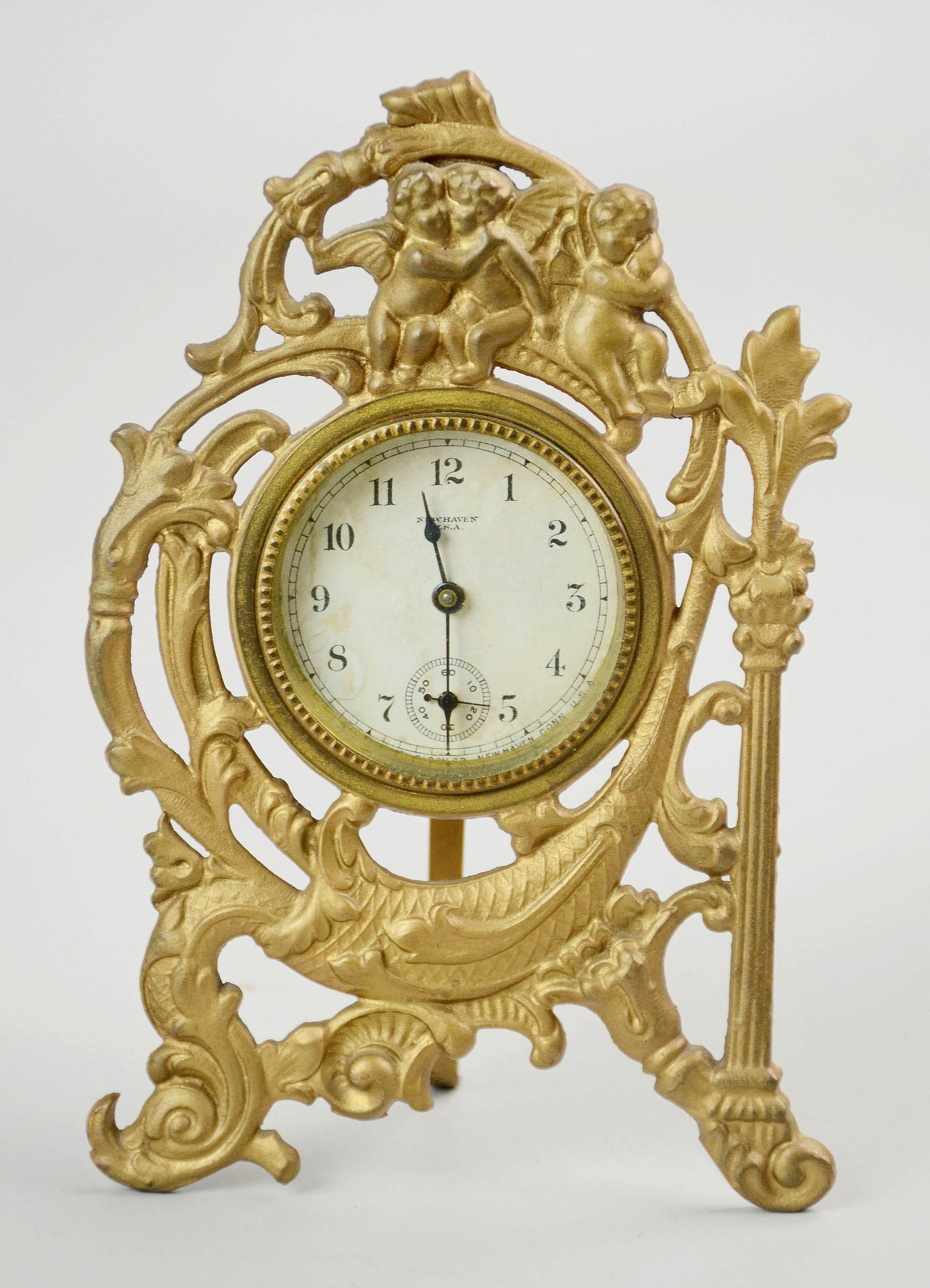 New Haven Art Nouveau Cherub Desk Clock: New Haven gilt metal desk clock, Art Nouveau with cherubs, late 19th-early 20th C, 6-3/8" h x 4-1/4" w