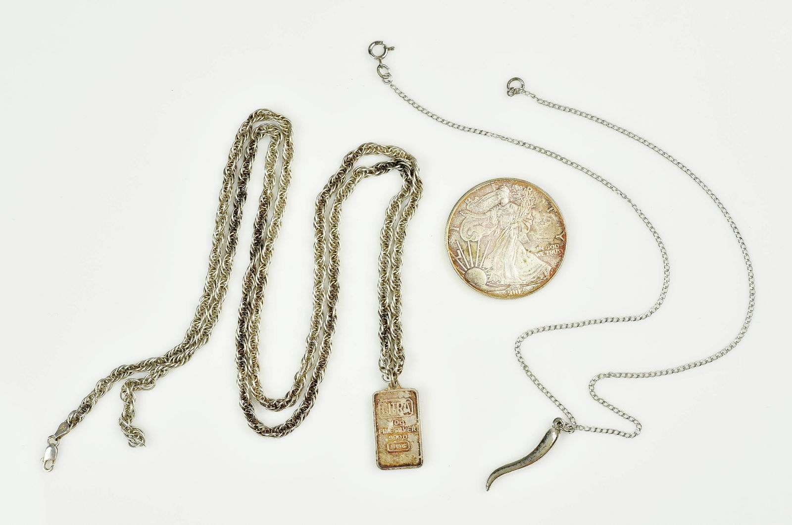 Silver Collector Lot Assey Bar Jewelry and Coin: Silver Collector's Lot C/O; (1) 2002 US Liberty Coin Fine Silver One Dollar 1 OZ. Coin, (1) 10G. Assay bar pendant "CITRA 10G Fine Silver 999.0 SBG Assay Bar Pendant on a long 35" Silver Chain and (1)