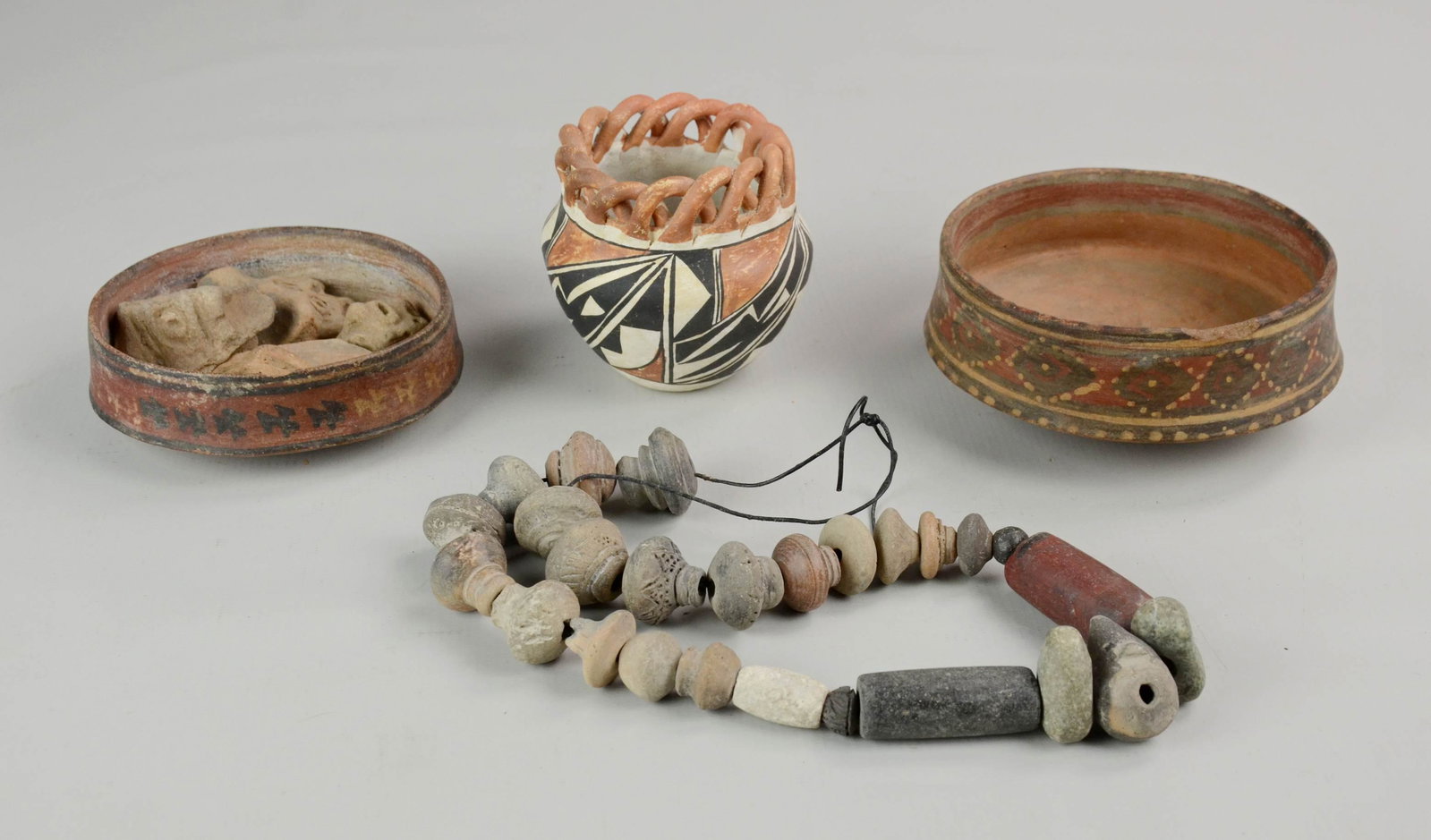 Pre-Columbian Style Redware: Pre-Columbian style redware c/o (2) painted vessels, 5" and 5-1/2". Grouping also includes Acoma pottery vase, figural pottery shards and pottery bead necklace.