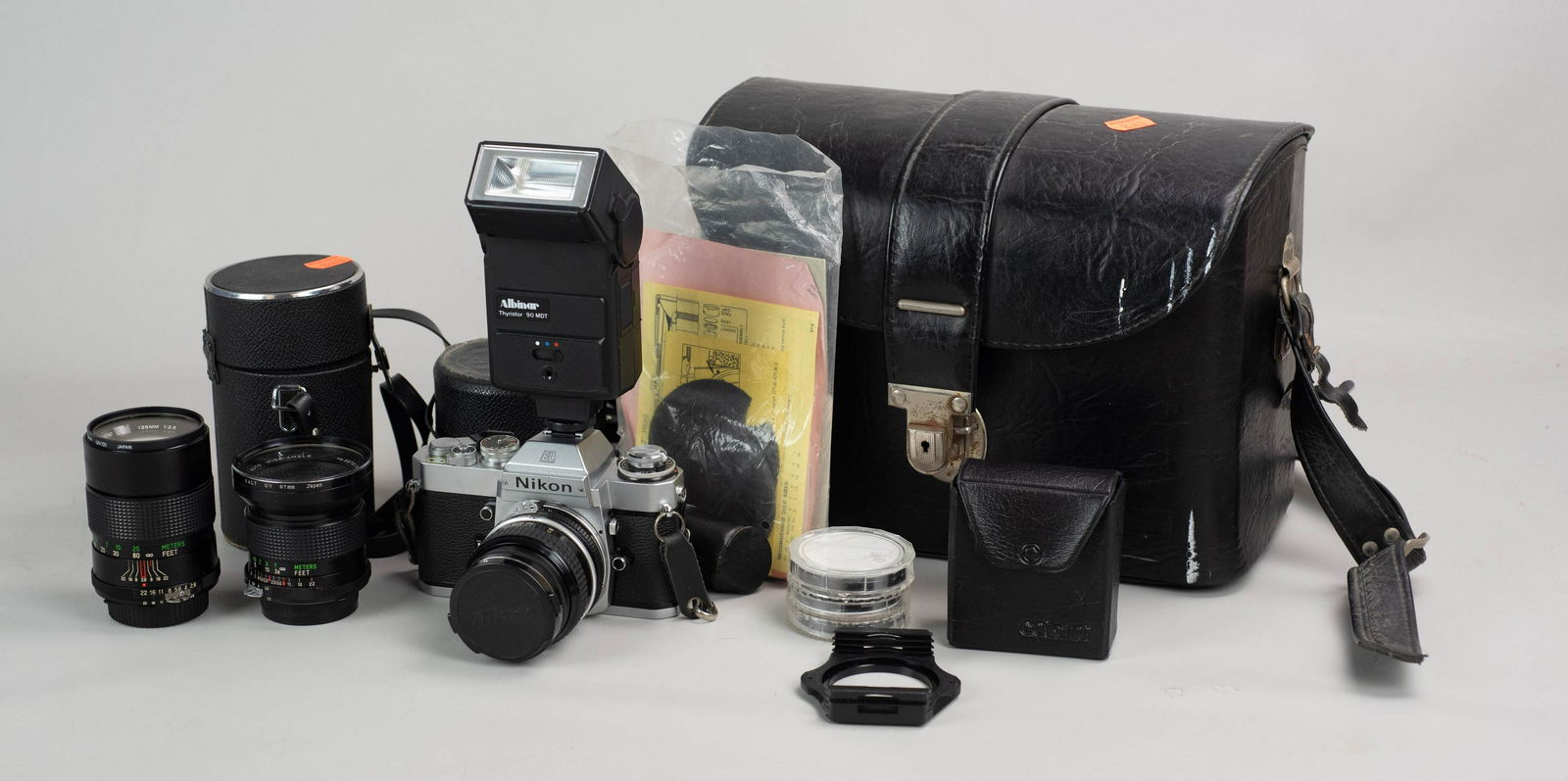 Nikon EL2 w/ 3 lenses, case and accessories: Nikon EL2 35mm SLR camera in good cosmetic condition, not battery tested though shutter is firing at mechanical speed. Includes Nikon 50mm 1:2 ai converted lens as well as vivtar 135mm 1:2.8 lens and