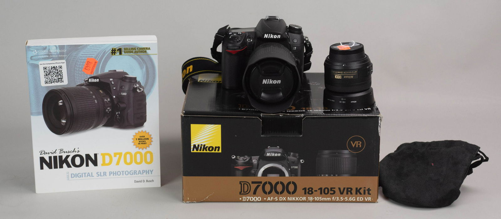 (3) Nikon D7000 DSLR w/ 2 Lenses: Nikon D7000 DSLR camera in like new condition, includes original box with paperwork. Lenses included are Nikon Nikkor AF-S DX, and are as follows 35mm 1:1.8G and VR AF-S 18-105mm 1:3.5-5.6 ED.