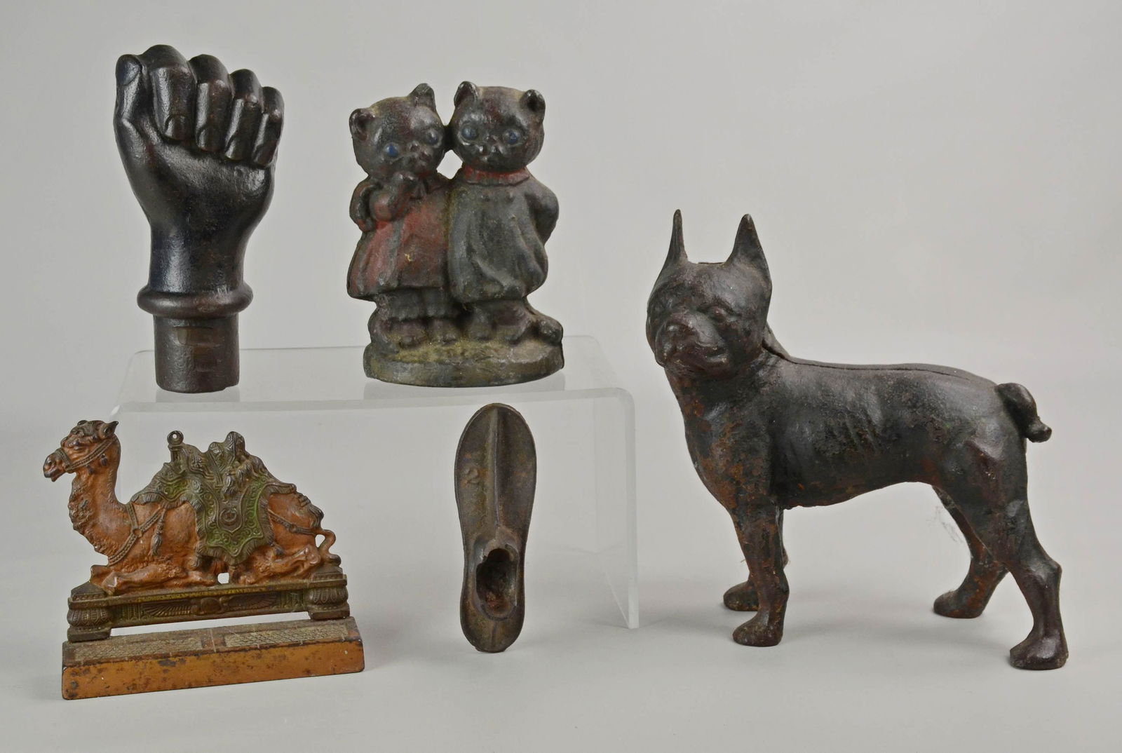 (5) Cast Iron Doorstops and Articles: (5) Cast iron door stops and articles c/o hand form hitching post, filled in center, Boston Terrier door stop, cat couple door stop, cast iron shoe form and Franz Bergman style camel.