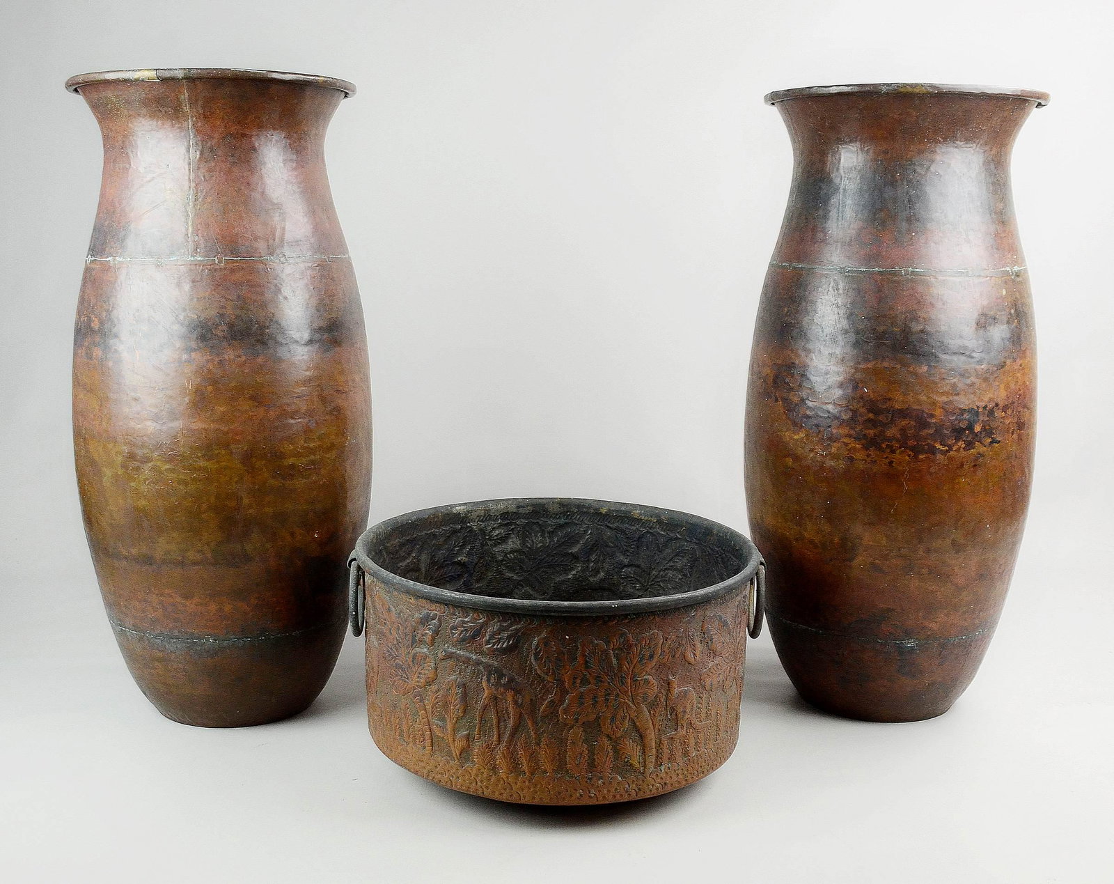(3) Copper Vessels: (3) Copper vessels c/o (1) pr oversized hammered copper vases, 21-1/2" and (1) animal and foliage embossed double handled copper pot, 7-1/2" h x 12-1/2" diam