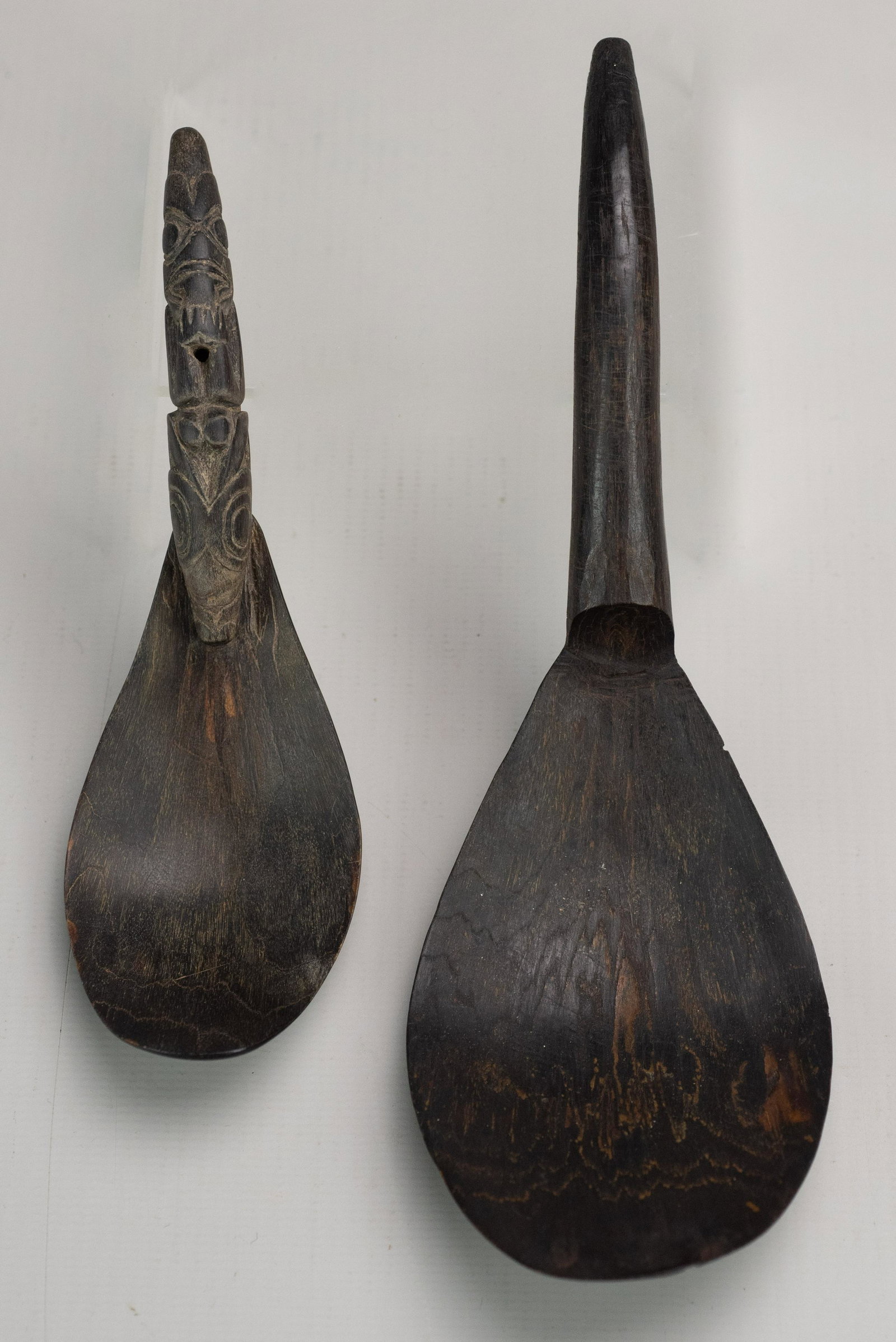 (2) Tlingit carved goat horn spoons: (2) Tlingit carved goat horn spoons, one with totemic handle, plain one 7 3/4" long, totemic handle 5 3/4" long