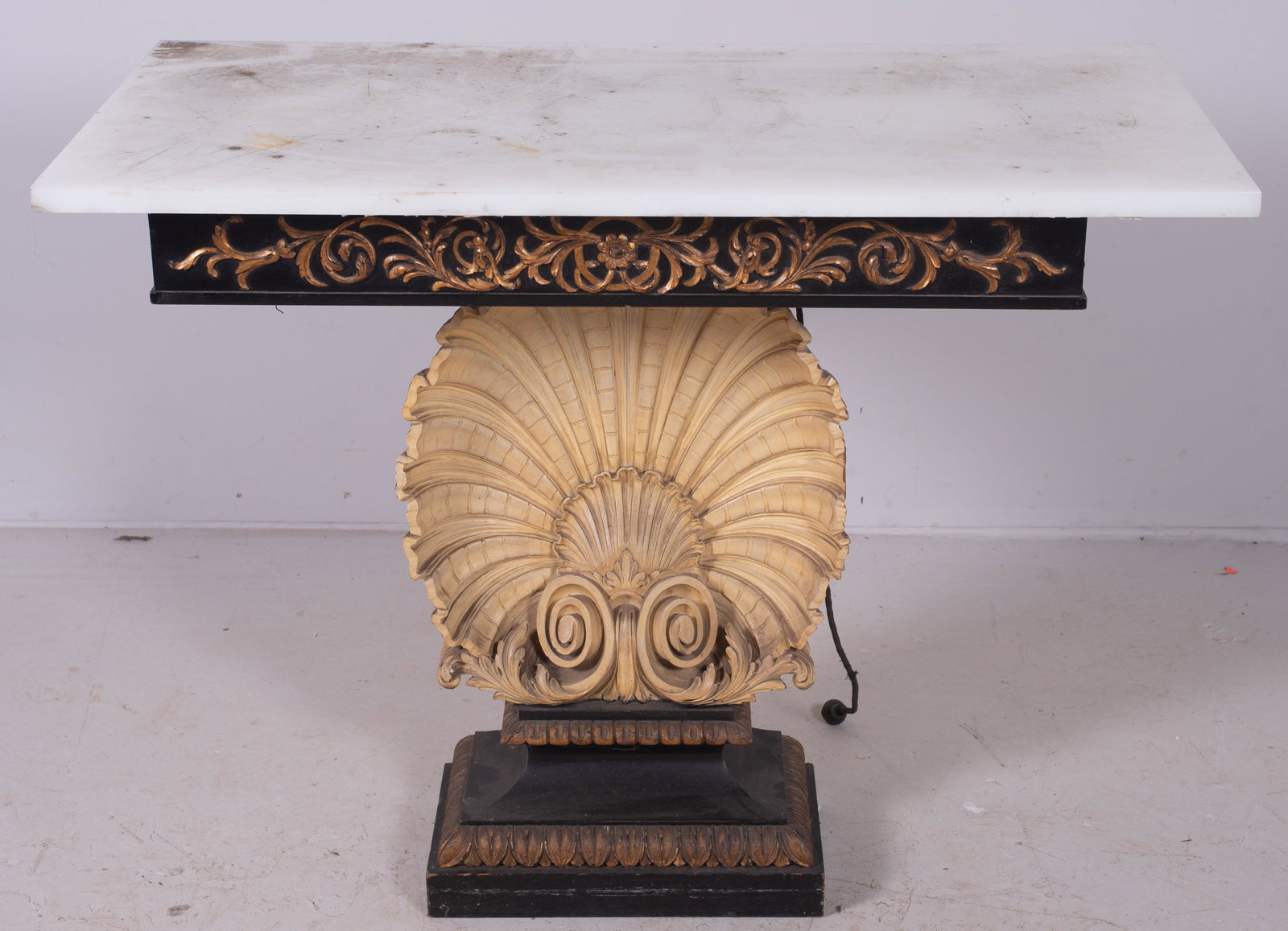 Regency style shell form console table: Regency style shell form console table, ebonized and gilt with cream painted carved wood shell, 35-1/2" h x 37" w x 14-1/2" d, fair condition, damage on side of shell, missing glass top