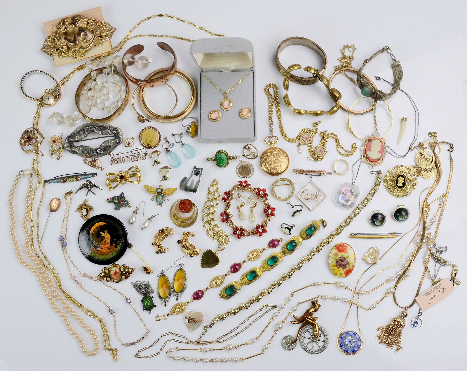 A collection of Vintage Art Deco Revival Jewelry: A collection of vintage Art Deco Revival Costume Jewelry C/O; Pins, Brooches, Bracelets , Earrings, some signed pieces, like Trifari,Karu Arke Inc, and Continental. Includes some gold filled items.