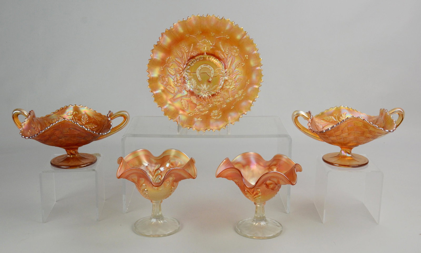 (5) Pcs Northwood Carnival Glass: (5) Pcs Northwood Carnival glass c/o (1) pr flower decorated ruffle edge compotes, 5 diam, (1) pr double handled cherry and basket decorated compotes, 5-1.2" diam and (1) ruffle edge Good Luck pattern