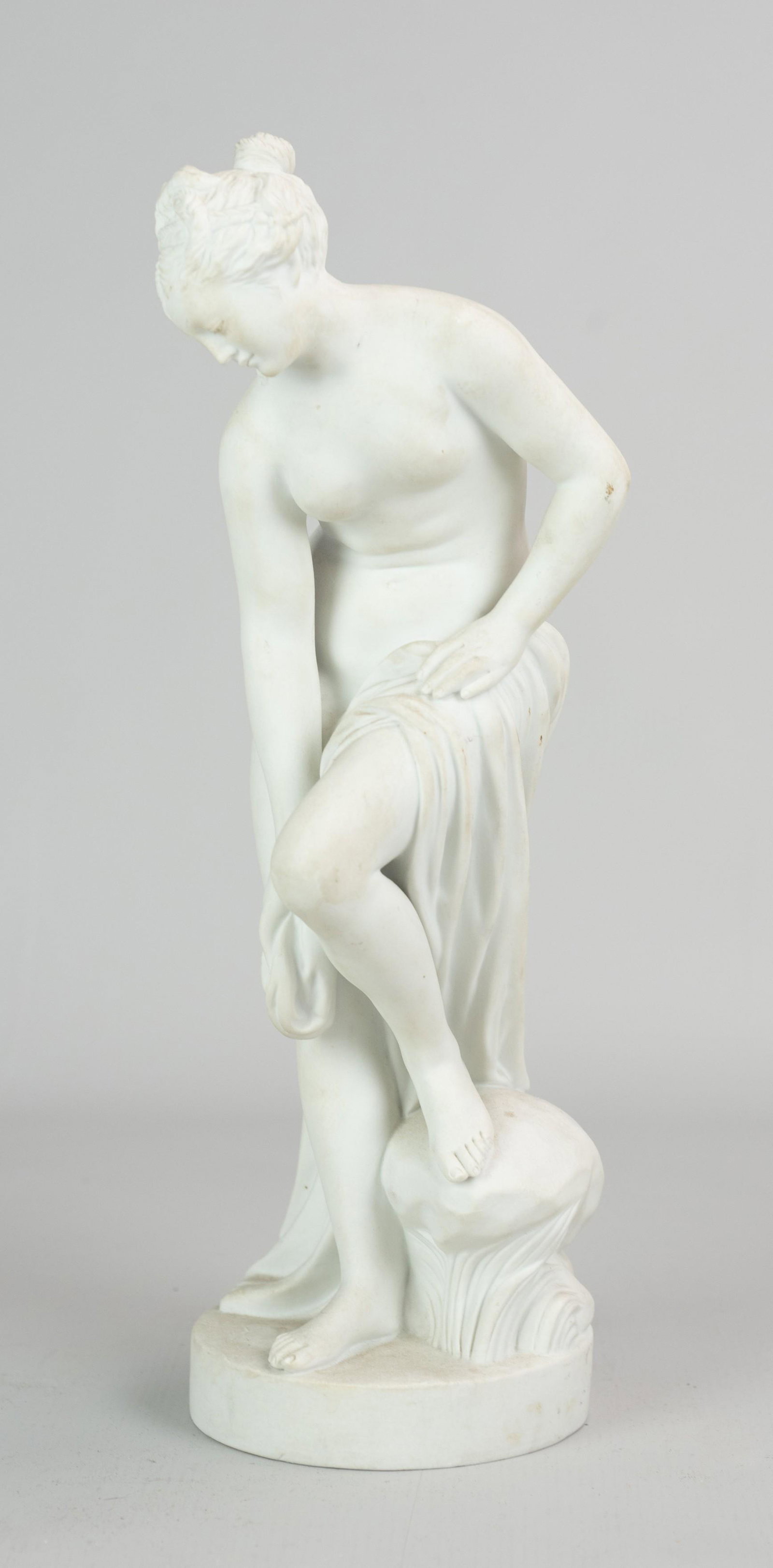 Sevres Bisque 'Bathing Venus' After Allegrain: Sevres bisque 'Bathing Venus' after Allegrain in state of undress with robe at leg gazing downward, signed "Allegrain' at back with Sevres mark, 13-1/2" , without flaw.