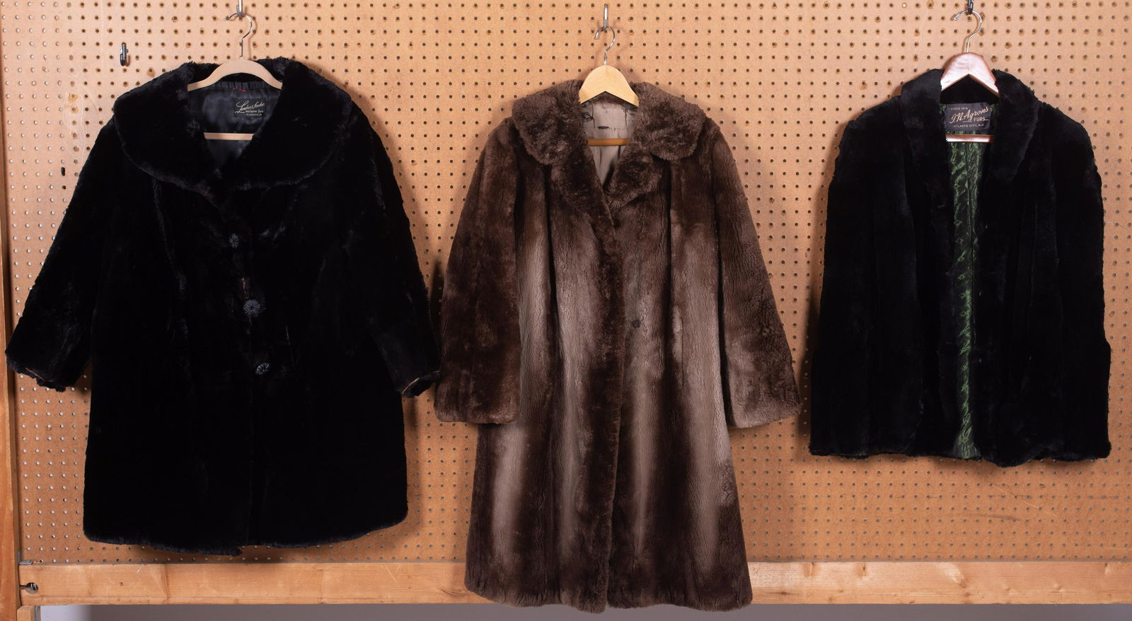 (3) 19th and 20th C. Fur Coats: (3) 19th and 20th c. fur coats (2) comprised of black fur, both with wear and some damage, (1) in cape form and (1) brown beaver coat, signs of wear but no tears to fur, some tears in lining. Please n