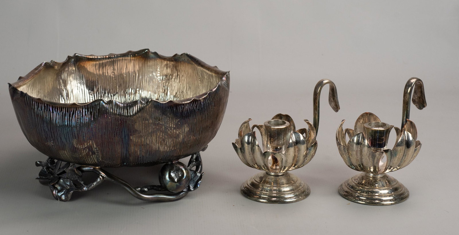 Silverplate Bowl and Candlesticks: Silverplate bowl and candlesticks c/o Hukin and Heath aesthetics movement textured bowl on branch, fruit and flower decorated foot, 10" diam x 5-1/4" h and unmarked floral form candlesticks pr with ha