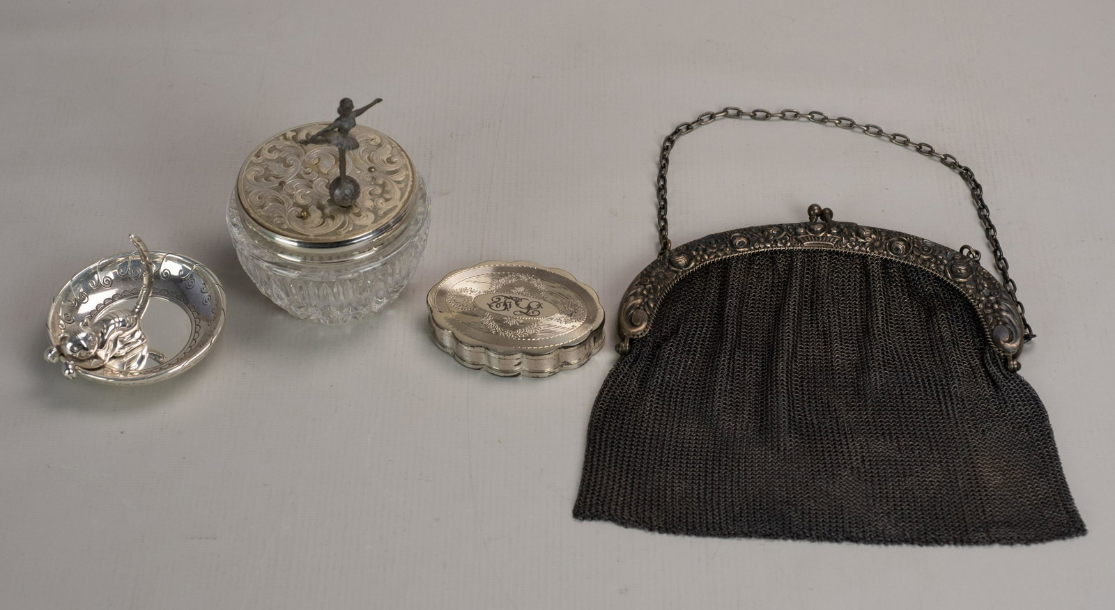 (4) Silver Dresser Items: (4) Silver dresser items, c/o Volupte sterling silver powder compact with mesh insert, 800 silver mesh purse (with repair), Brighton Kitty Kaddy silver plate ring dish, crystal & silver plate ballerin