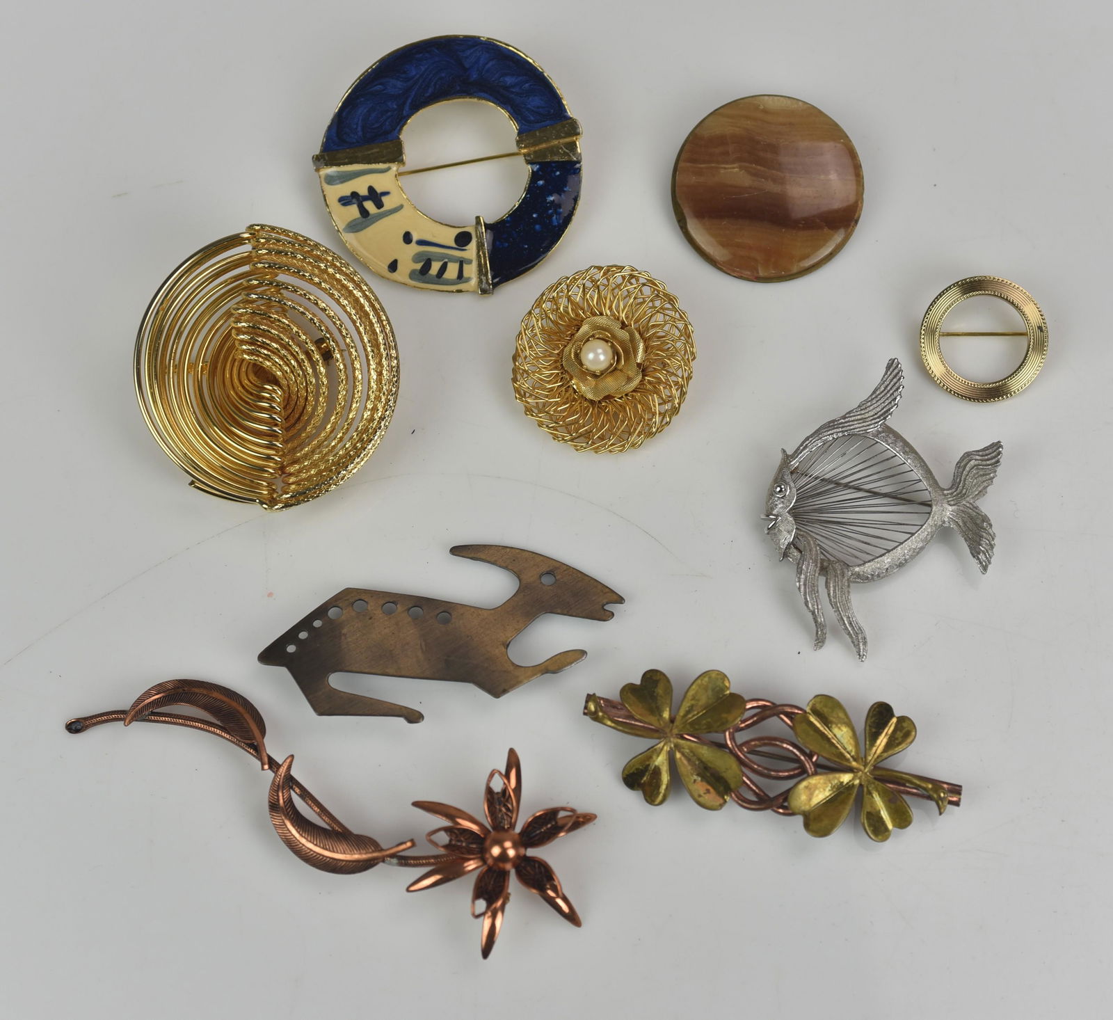 (9) Pc lot of Mid Century Modern Brooches: (9) Pc lot of Mid Century Modern Brooches, includes one copper floral brooch, one singed Monet and the others are unsigned