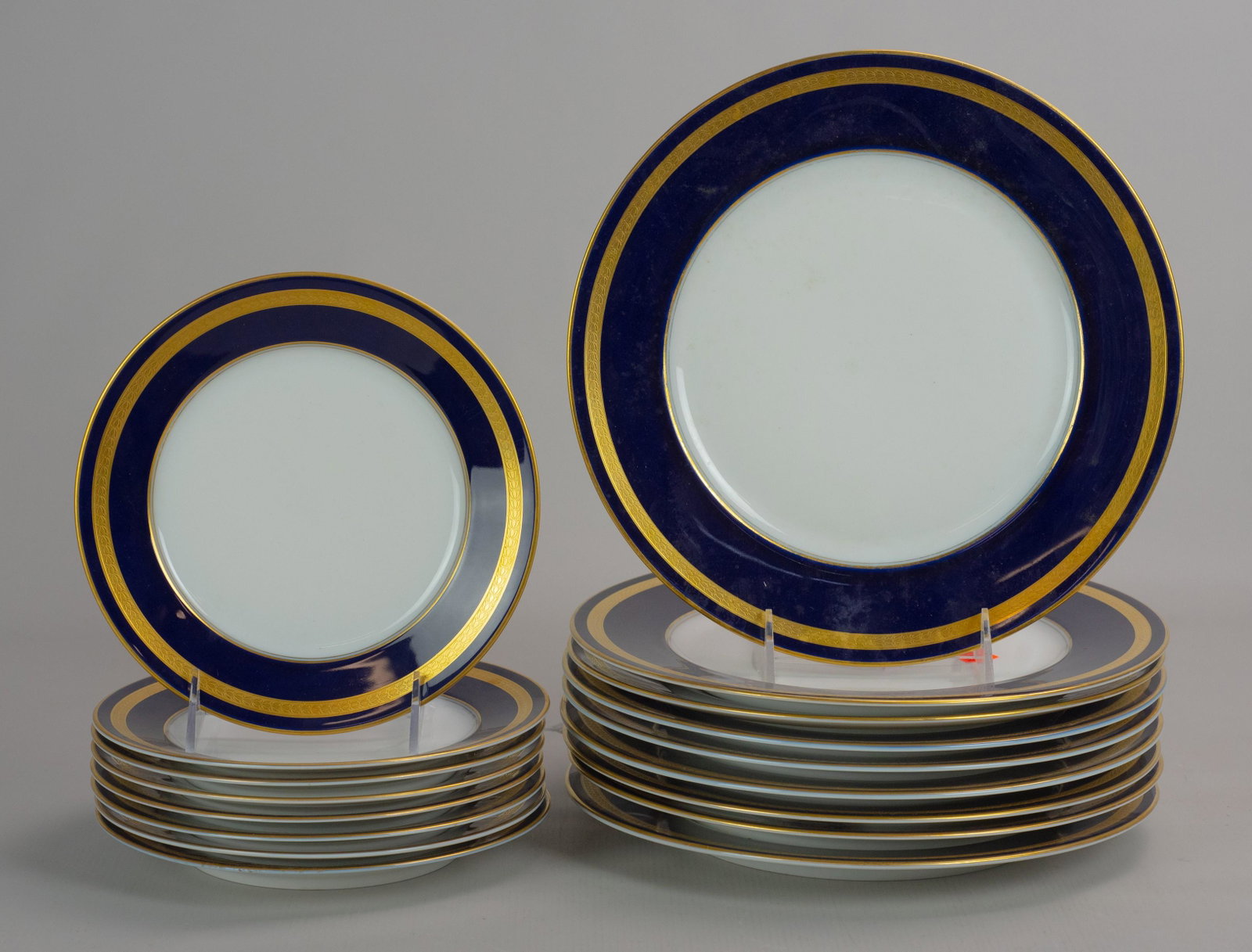 (17) Pcs Rosenthal Eminence Dinnerware: (17) Pcs Rosenthal porcelain plates, Eminence pattern, cobalt blue border with gold encrusted floral band, c/o (9) 10-1/2" dinner plates, (8) 7-3/4" salad plates. Some with utensil markings. Light wea
