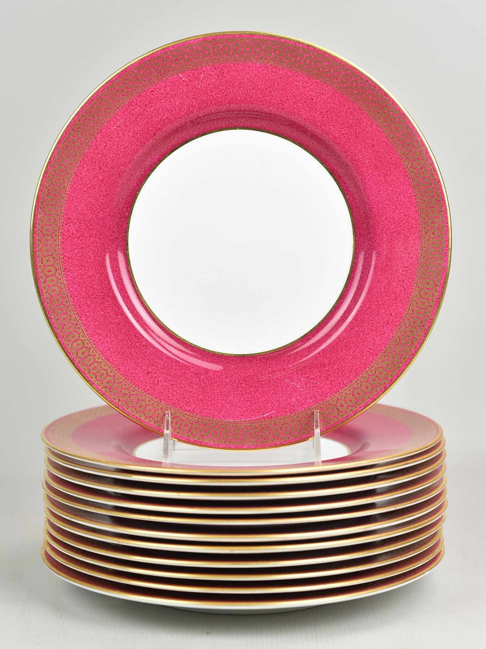 (12) Spode Copelands Dinner Plates: (12) Spode Copeland's dinner plates in raspberry rim with gilt patterned border, 10-1/4", All with flatware marks mainly noticeable on pink border. One with fleabite chip at edge.
