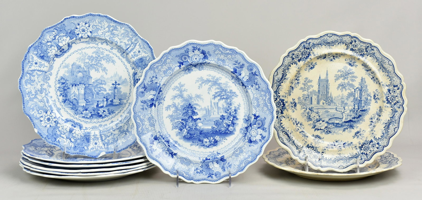 (9) Transferware Plates: (9) Transferware plates c/o (6) Adams Delphi blue and white transfer plates, 10-1/2", (1) with chip at edge, (2) Antiquarian plates, (1) with crack, 10-1/4" and (1) urn and castle decorated plate, 10-