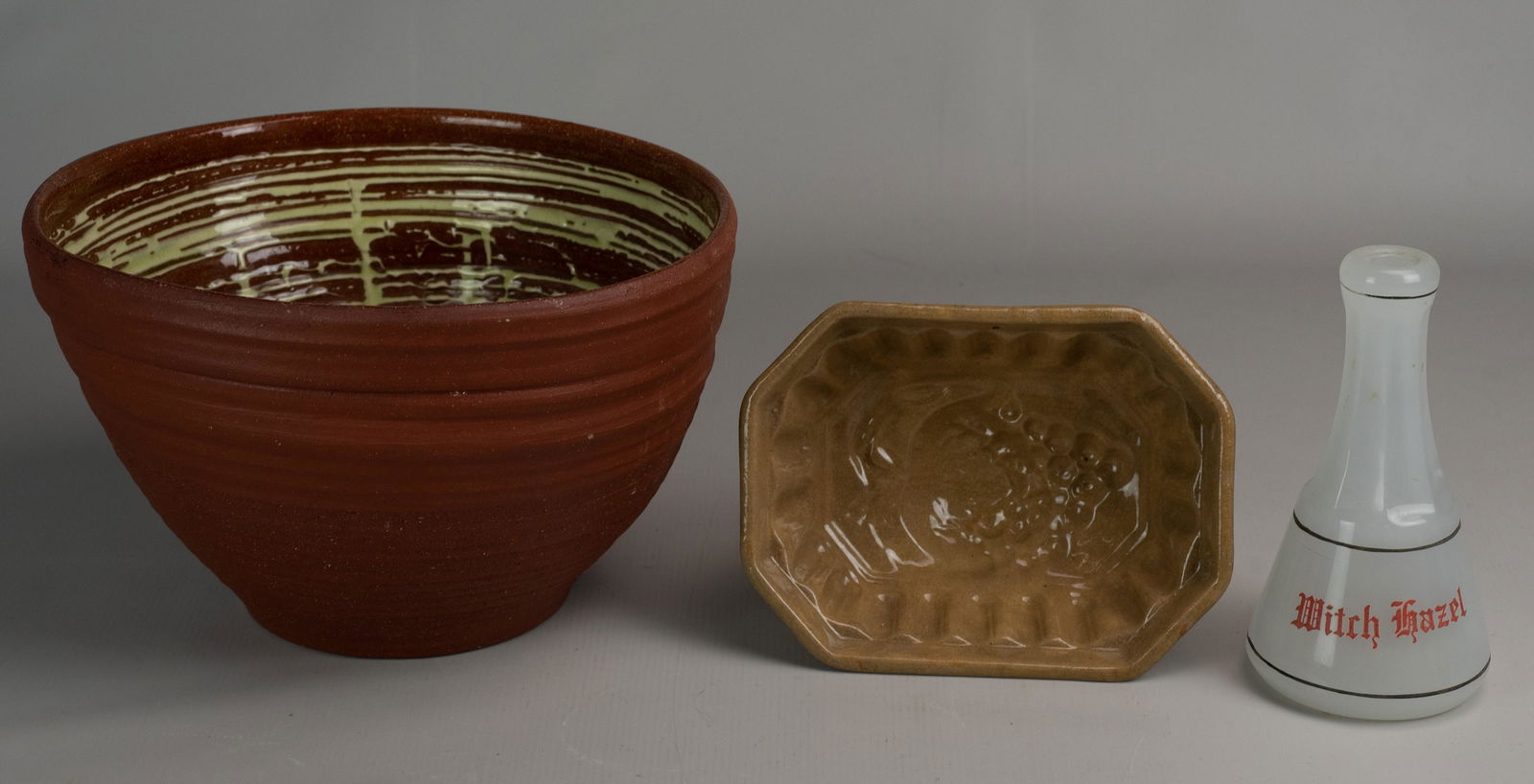 Stoneware Mold, Redware Bowl and Bottle: Stoneware mold and redware bowl c/o grape form stoneware butter mold, 7-1/2" diam, redware mixing bowl with drip glazed interior, signed illegibly at underside, potentially Victoria Sullivan Morris, 9