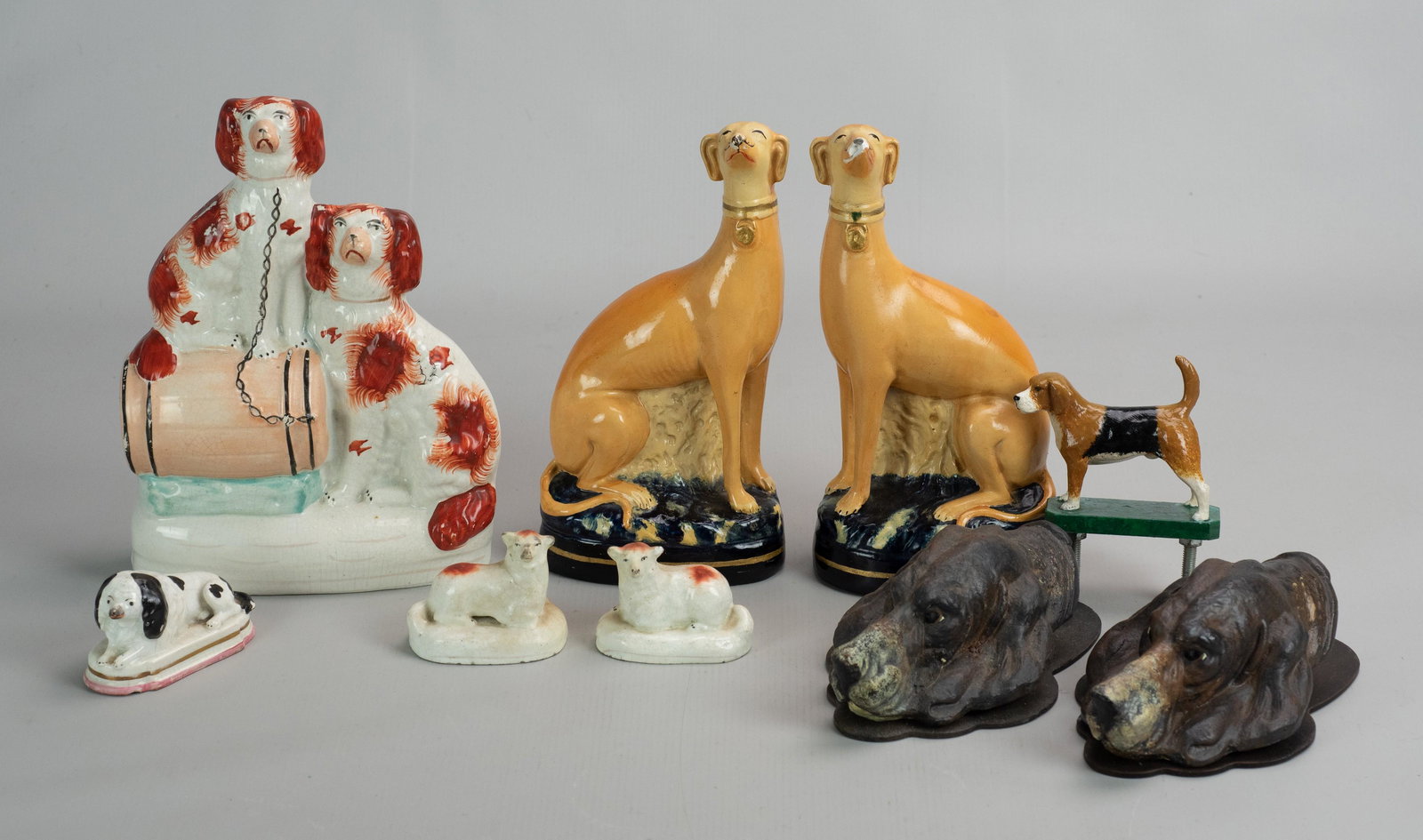(9) Pc Dog Grouping: (9) Pc dog grouping c/o (2) modern hound form clips, 7", PR staffordshire laying dogs, 2-5/8", single laying staffordshire dog, 3-1/4", PR painted plaster whippet bookends, both with damage at head an