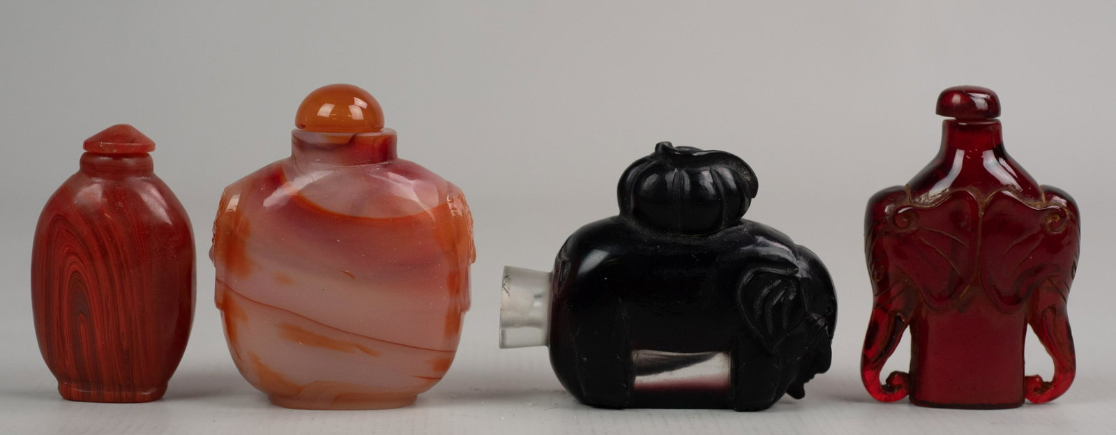 (4) Chinese Snuff Bottles: (4) Chinese snuff bottles c/o glass & stone, 1 w/elephants, tallest 3" h, one missing stopper
