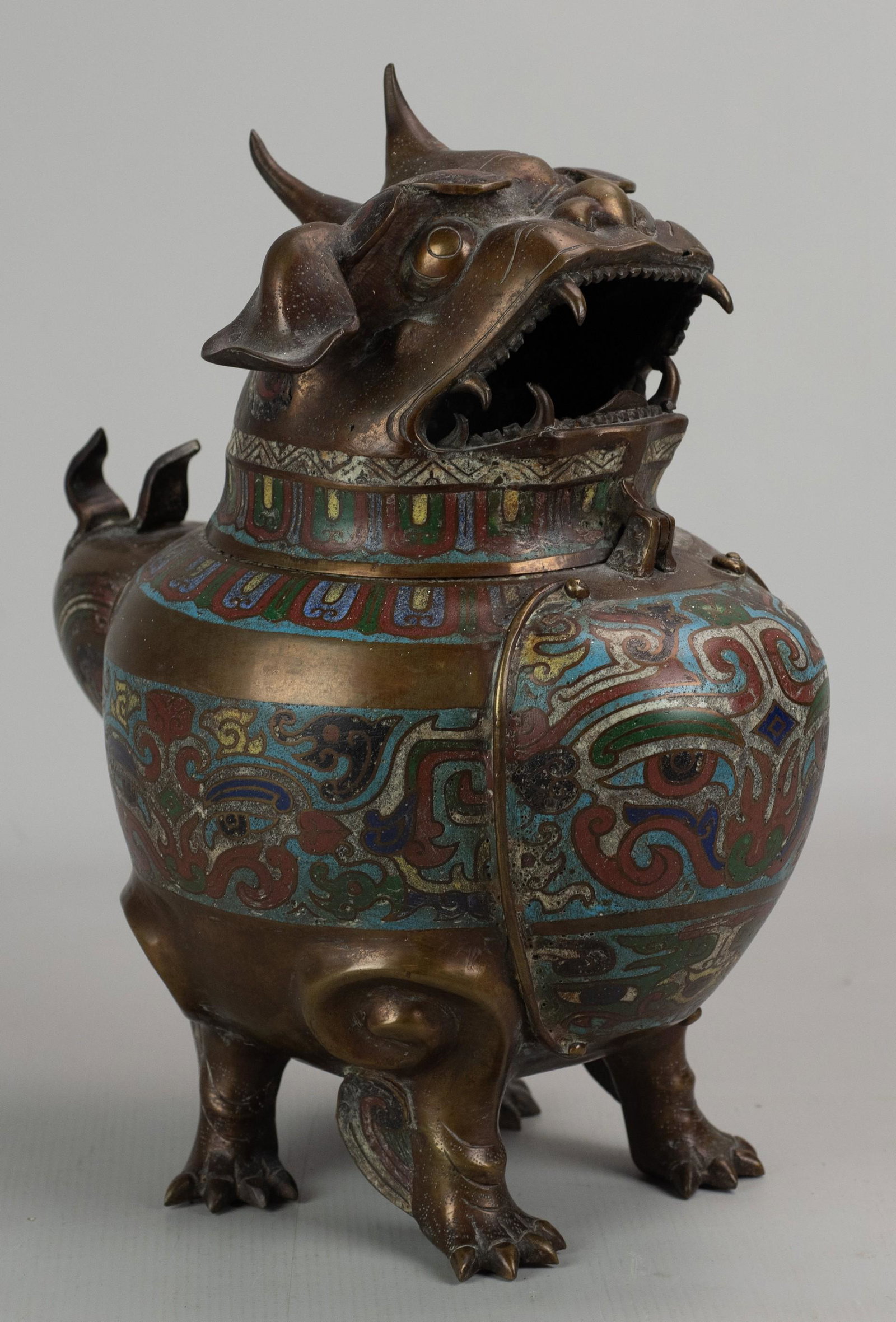 Meiji Style Japanese Champleve Figural Censer: Meiji style Japanese champleve figural censer in dragon/dog form with hinged lid, open mouth, decorated body and paw feet, 12-1/2" h, implement rest at back, 1/2" hole and top lip, rubbing on nose