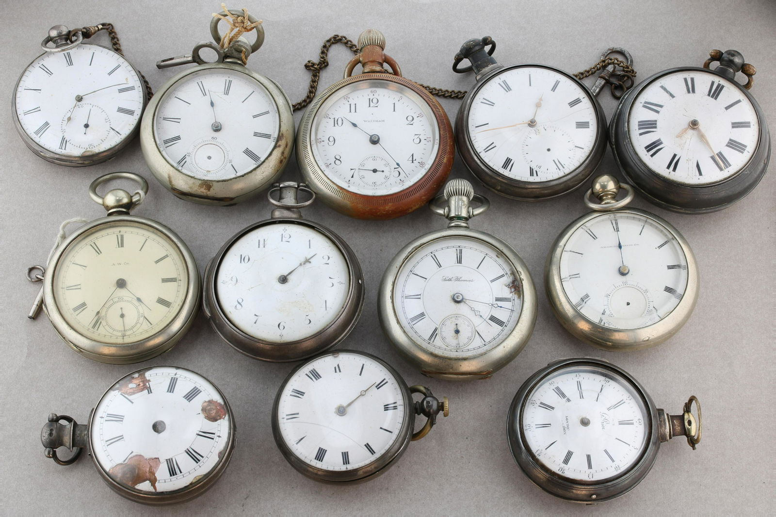 Cased Pocket Watches Late 1890: (12) Pc lot of Cased Pocket Watches Late 1890's. (6) marked Silver, one is marked G. PRior London,another is marked Roskell, , (6) are nickle or silveroid, some come with wind key attached. Sold for p