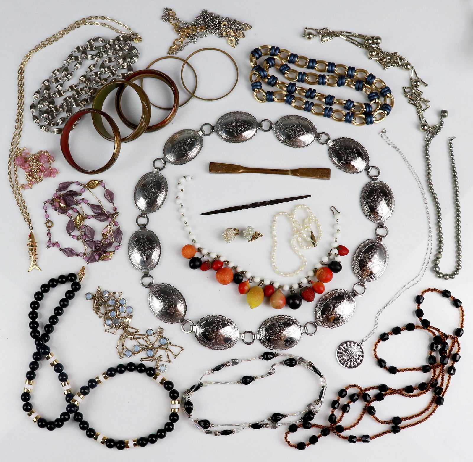 Costume Jewelry Lot: Costume Jewelry Lot C/O; (1) steel concho belt, (7) Costume Bangles, (1) blue and gold link chain, (1) Singed "Monet" Silver Beaded Chain, (1) Accessocraft articulating fish necklace, (1) unsigned blu