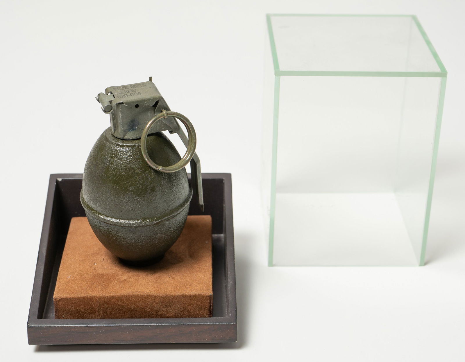 Adam Stennett Sculpture "Hand Grenade": Adam Stennett (American, b 1972) sculpture "Hand Grenade", cast metal in glass and wood case, signed on handle "Adam Stennett 2008", edition 1/12, overall size 5-1/8" x 4-1/4' x 1/4", very good condit