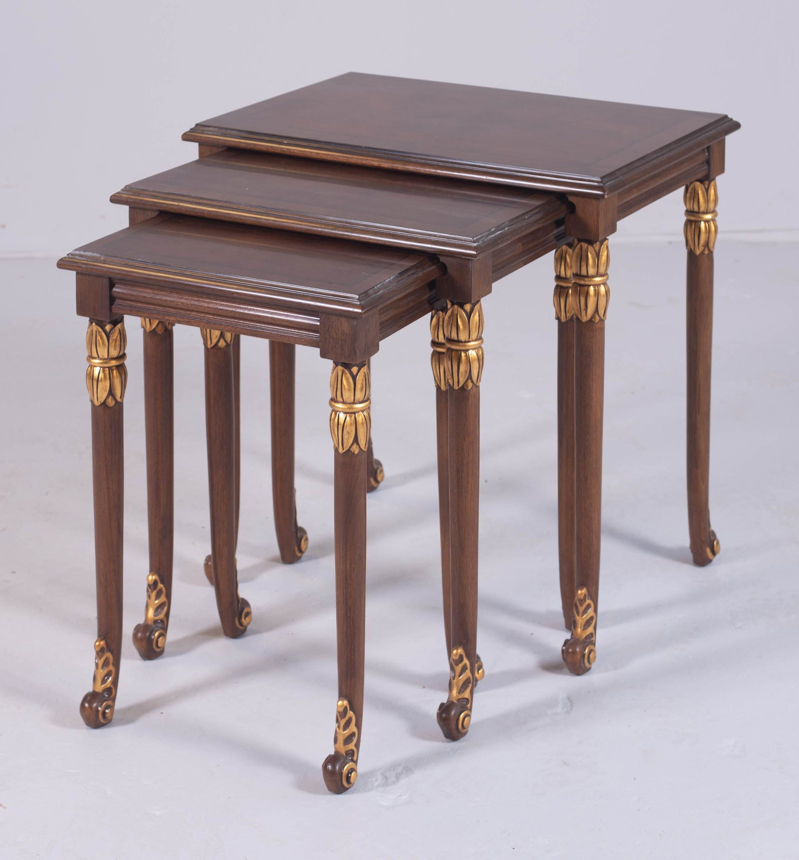 Set of Karges Italian style walnut nesting tables: Set of Karges Italian style walnut nesting tables, gilt highlights, largest 23" h x 23" w