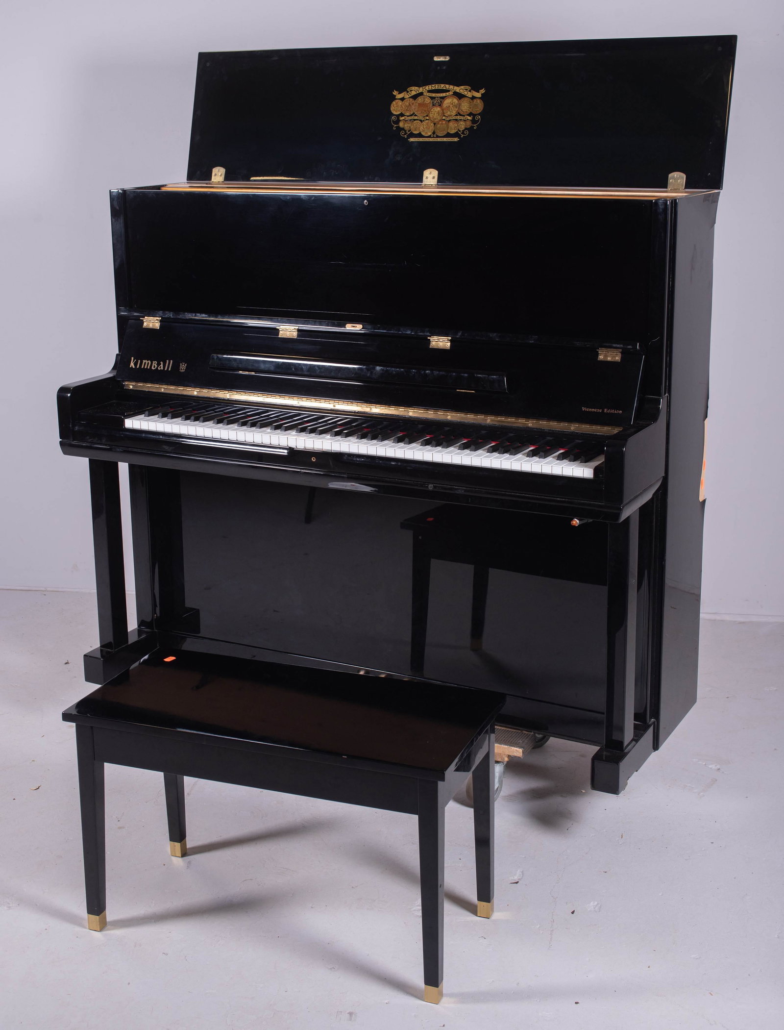 Kimball Ebonized upright piano w/ bench: Kimball Ebonized upright piano w/ bench, Viennese Edition, Model C520, Serial D82221, Kimball Life Crowned toneboard, 51-1/2" h x 59" w, some veneer damages