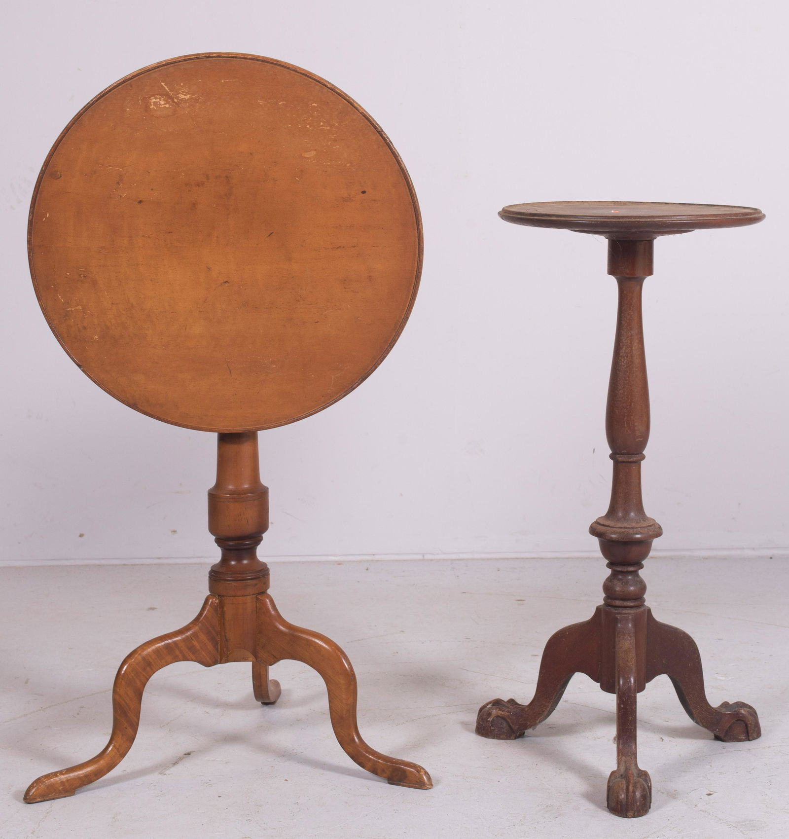 (2) candle stands: (2) tea tables, c/o Chippendale style mahogany with turned post, wear to finish, maple Federal style flip top, turned post, wear and scratches, largest 27" h x 19-1/2" diameter