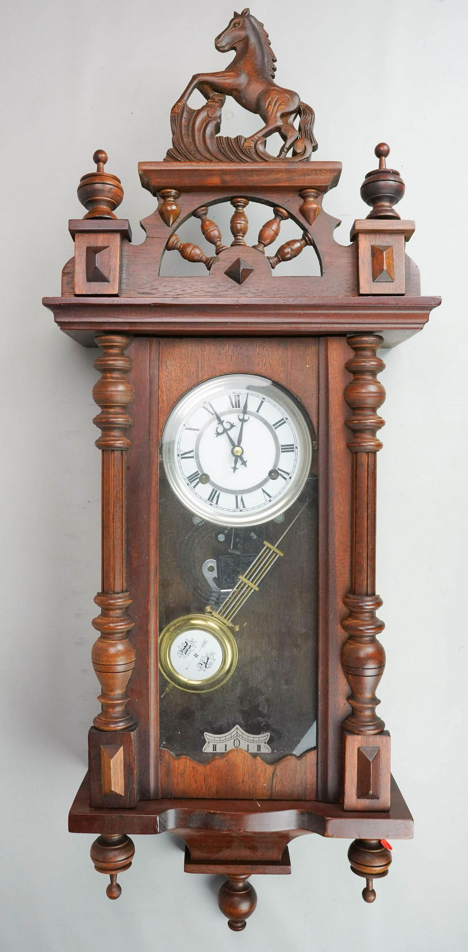 Mahogany German spring driven wall regulator, 38": Mahogany German spring driven wall regulator with horse crest, enameled dial, time and strike, runs when wound, no warranty, 38" high, cracked door glass