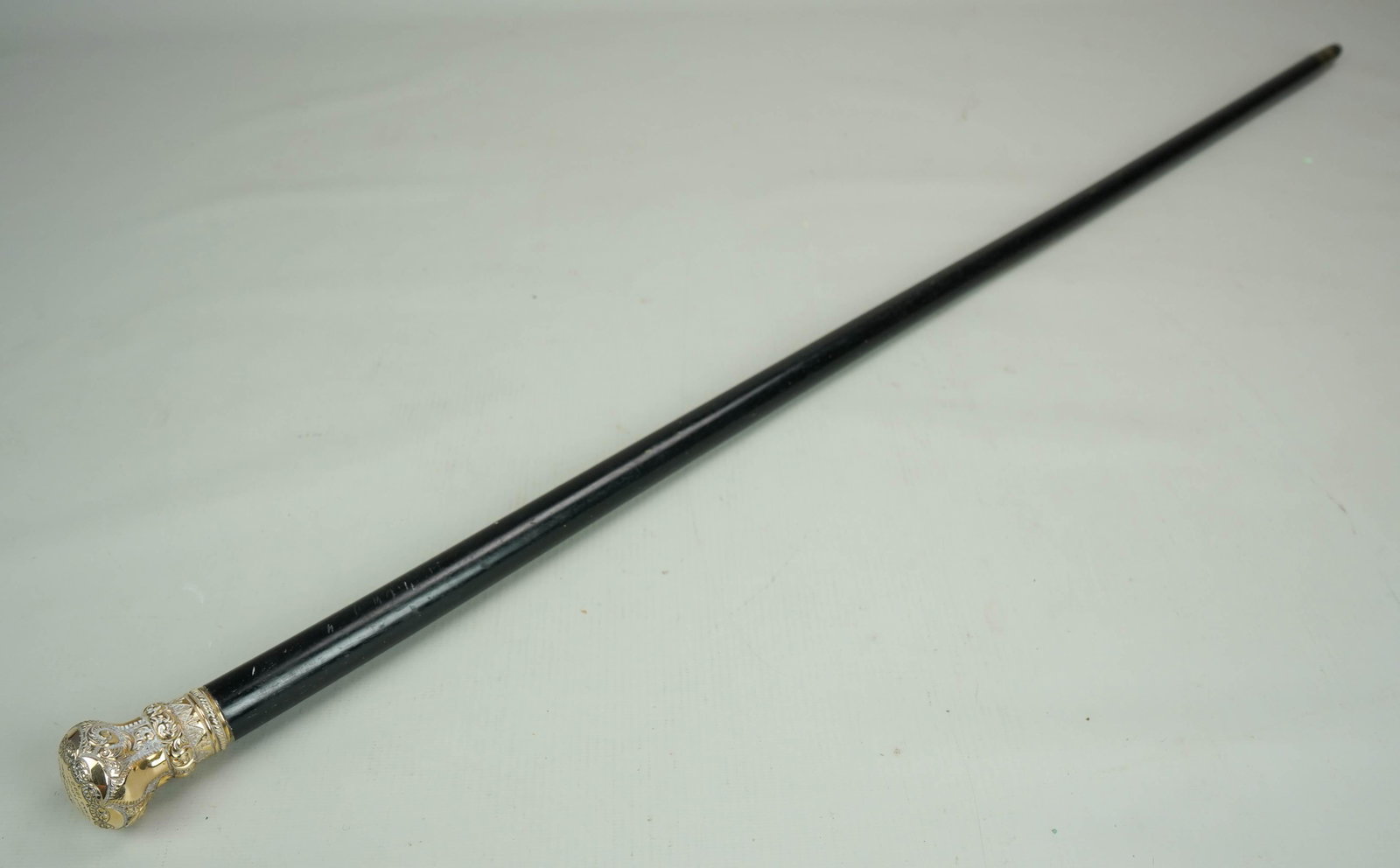 19th c. 14k Gold Capped Presentation Walking Stick: 19th c. 14k Gold capped presentation walking stick engraved, "Presented to Captain E.L Rice Jr. by Troop B as a token of their esteem, x-mas 1892", ebonized wood body, cement filled top, 35" h