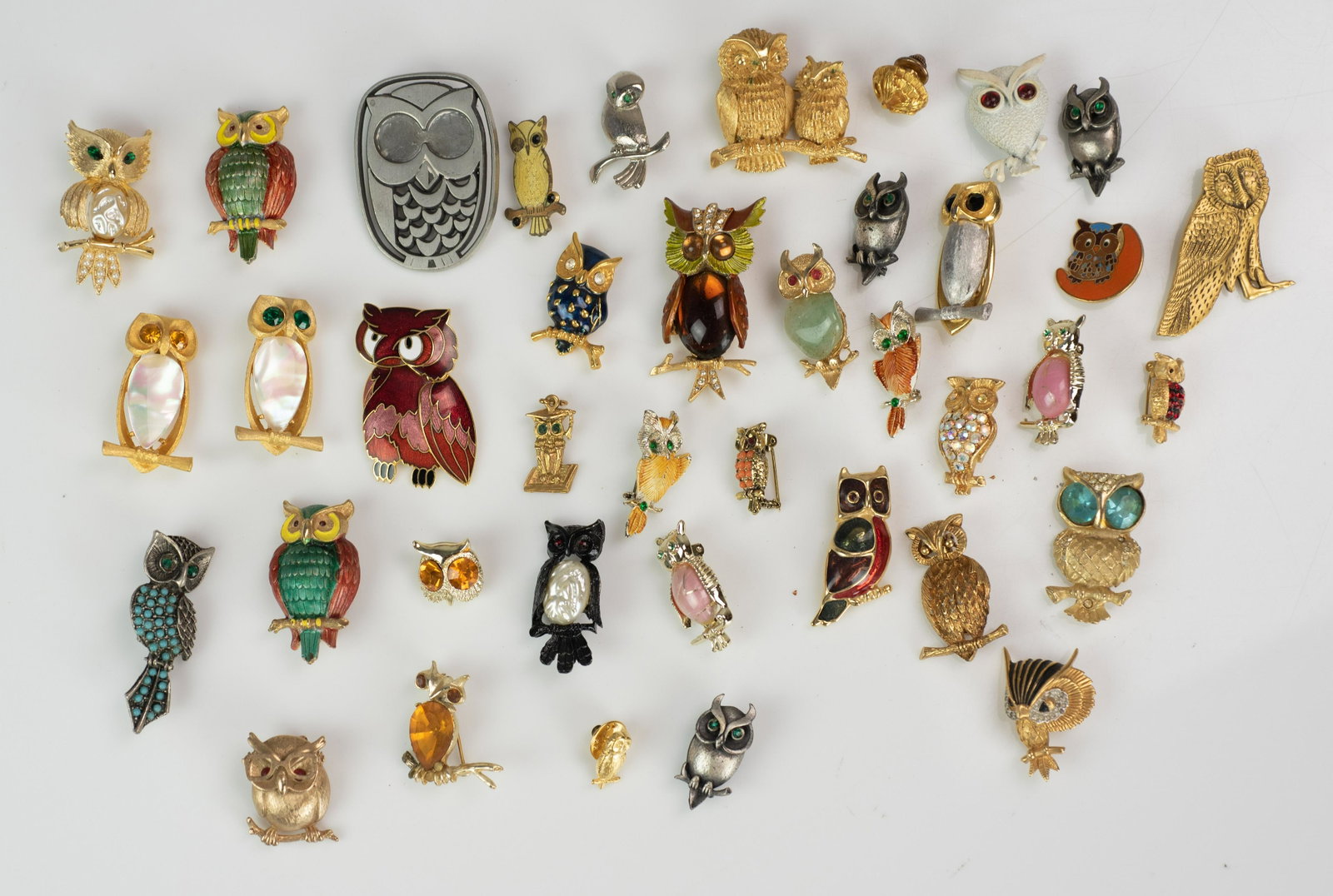 (39) PC lot of Costume Owl Brooches: (39) Pc lot of Costume Owl Brooches C/O; mixed brands, mostly Branded JJ, includes one pewter owl brooch and one pendant. Most are in good, but worn condition.
