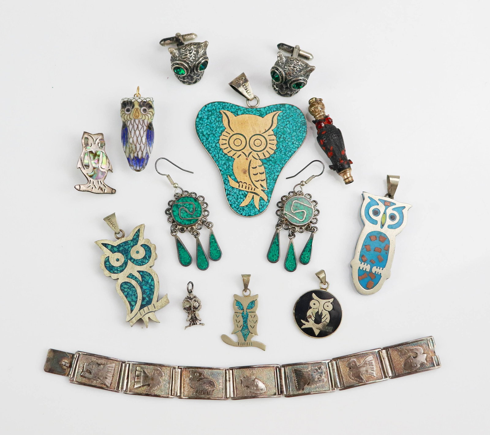 (12) Pc Silver and Alpaca Jewelry Lot: (1) Sterling Mexican Panel Bracelet, (1) metal possibly pewter, (1) pair of Alpaca earrings, (4) alpaca and crushed stone owl pendant, (1) cloisonne Owl pendant, (1) Mixed metal Signed " AVM Metales" 
