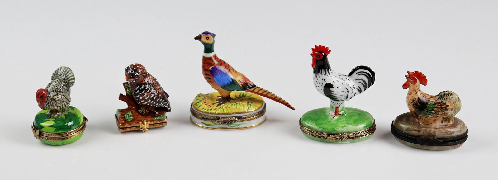 (5) Bird Decorated Porcelain Trinket Boxes: (5) Bird decorated porcelain trinket boxes c/o pheasant topped box marked Limoges at underside, (2) Rooster topped boxes marked Limoges at underside, turkey topped trinket box marked Limoges at unders