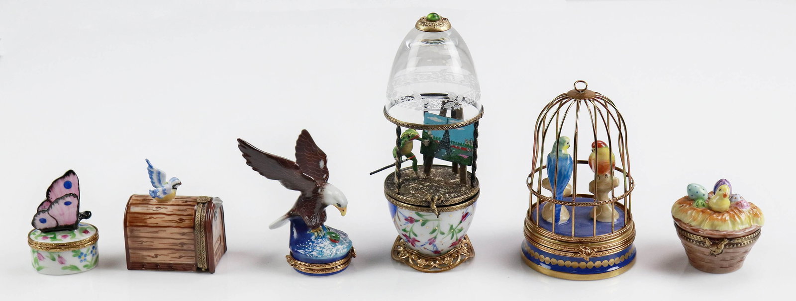 (6) Assorted Limoges Trinket Boxes: (6) Assorted Limoges trinket boxes c/o egg form trinket with frog painting eiffel tower at center, eagle and fish topped trinket, Easter egg and chick basket form trinket, caged bird pair trinket, blu