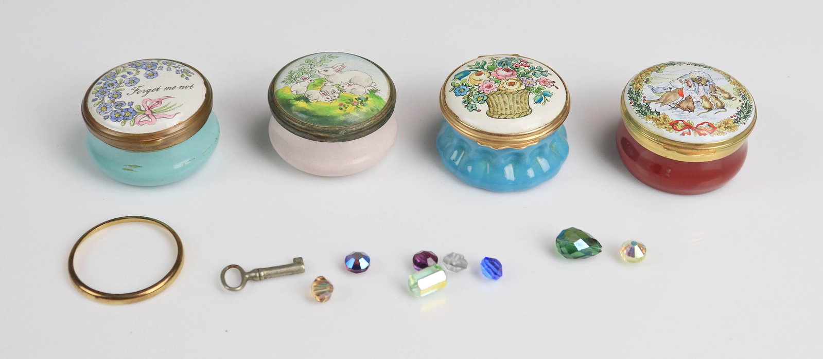 (4) Enamel Trinket Boxes: (4) Enamel trinket boxes c/o Halcyon Days Bilston and Battersea 'Forget me not' topped box, Halcyon Days Bilston and Battersea floral basket topped box, Crummles and Co. Beatrix Potter decorated box m