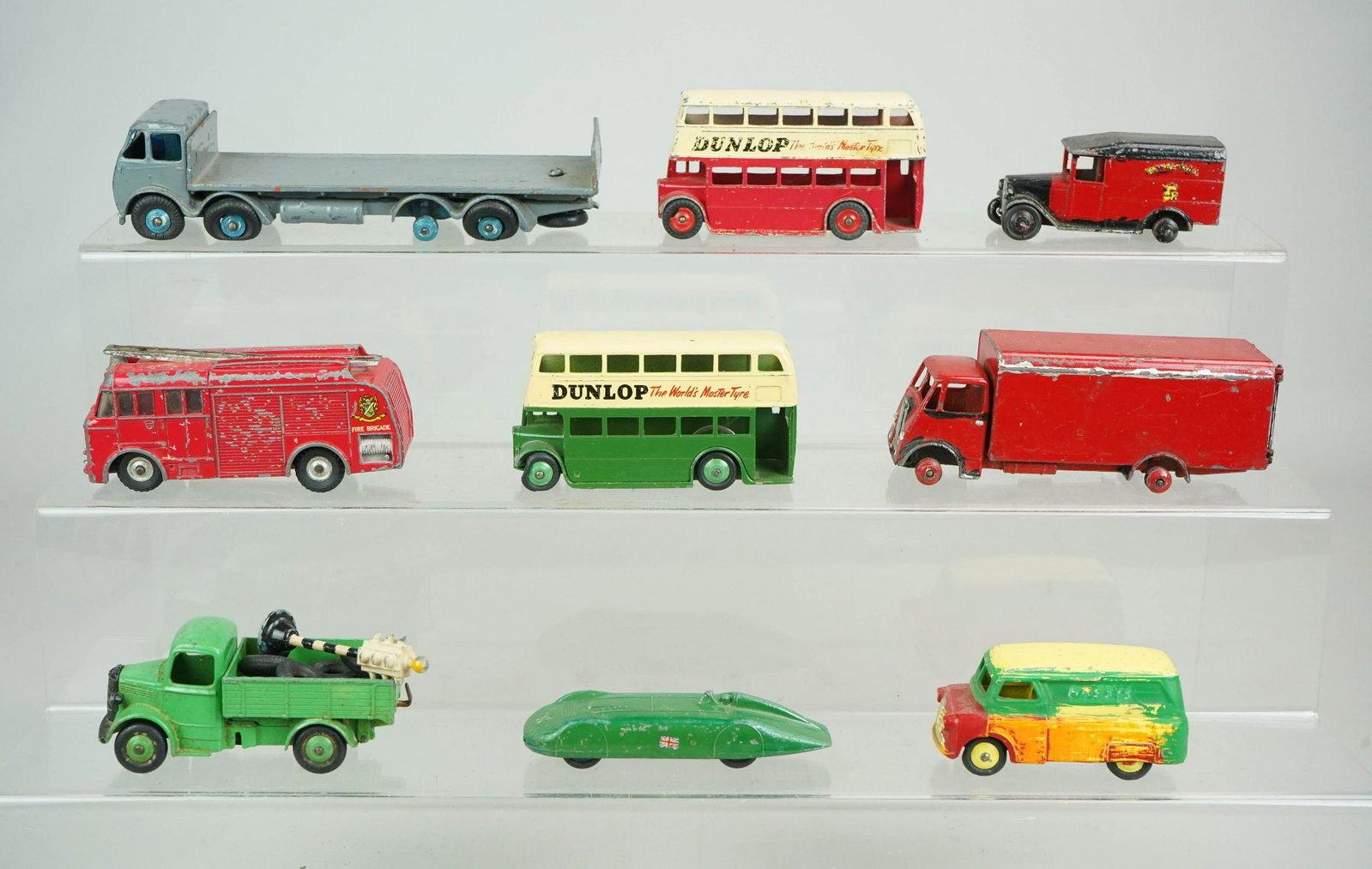 (9) Dinky Toy Diecast Vehicles: (8) Dinky Toy diecast vehicles c/o Royal Mail truck, lift back truck, MG Record Car, van, (2) double decker buses, fire engine, flatbed truck and box truck, some missing tires. Includes extra tires an