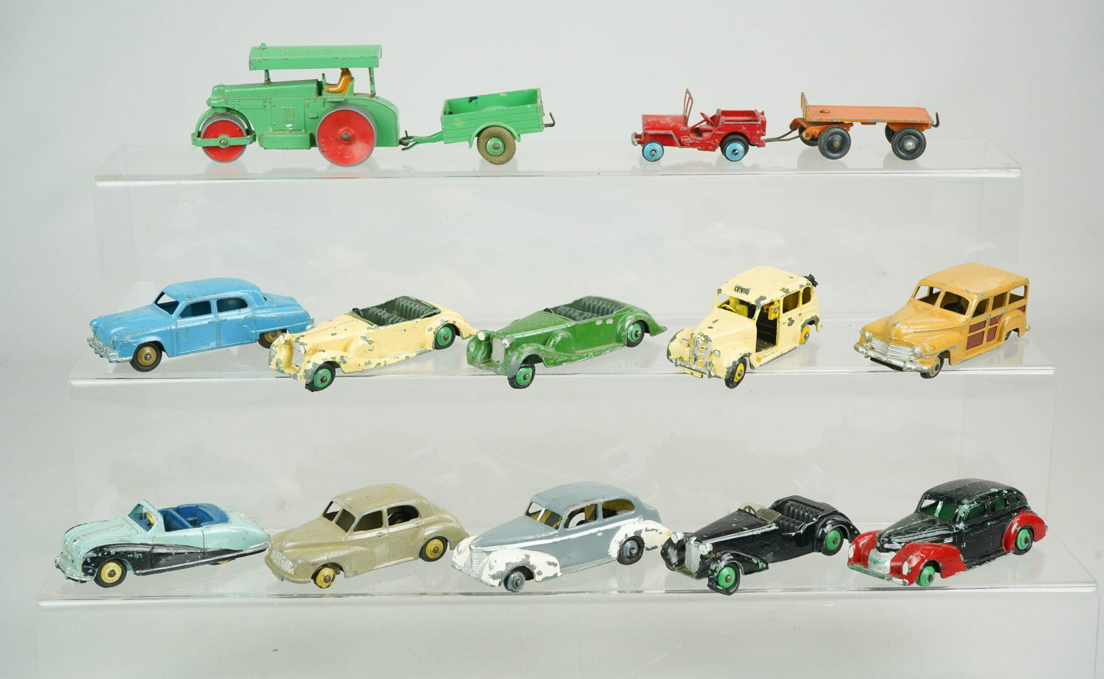 (13) Dinky Toy Diecast Vehicles: (13) Dinky toy diecast vehicles c/o Aveling Barford roller with cart, jeep, flatbed hitch, woody, austin taxi, (2) Lagonda cars, (1) Alvis car, Morris Oxford car, Austin Atlantic car, studebaker, chry